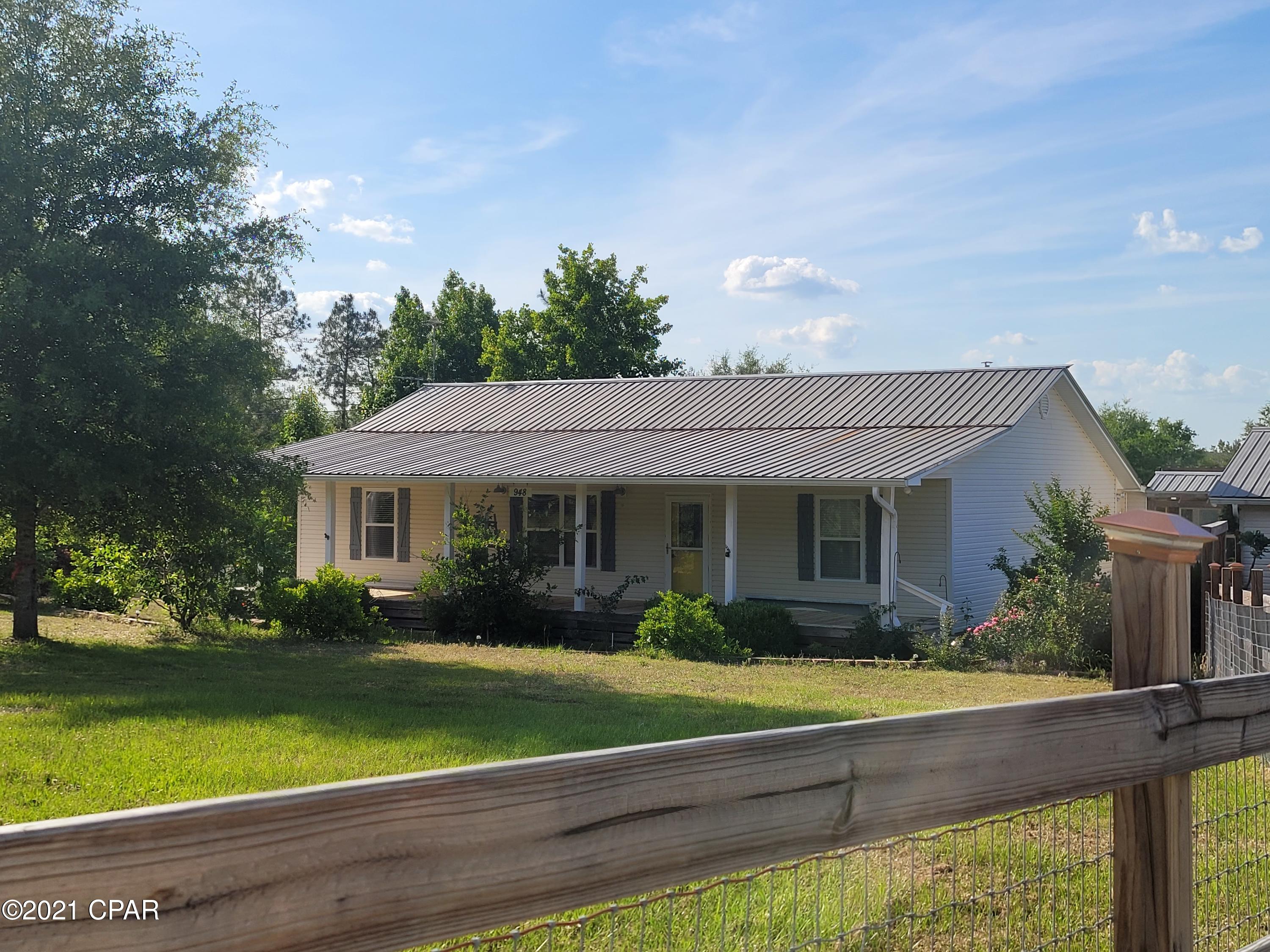 Comp Sale Purposes Only- Spacious 3/2 home on 10 acres. Home offers an open kitchen, dining, and living area. Kitchen has plenty of storage and a breakfast bar. Split floor plan with master bedroom and master bath with large tile shower and walk in closet. Florida room and laundry area are located at the rear of the home. Back deck with a separate porch needing screens. Detached garage and workshop with electric and additional storage, and lean to for equipment. 2 additional storage buildings. Close to town for the amenities Defuniak Springs has to offer.