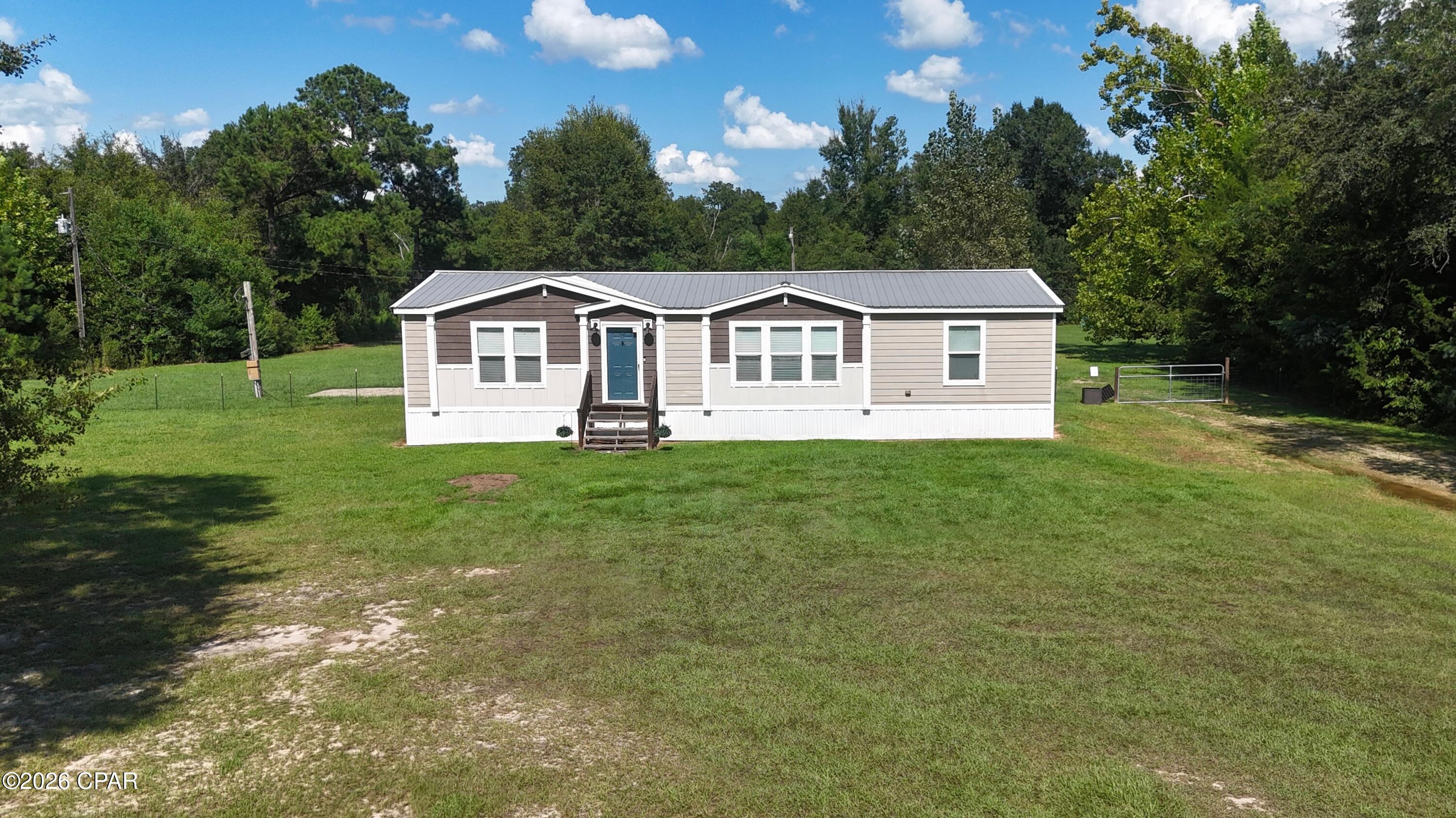 Situated on 5.18 acres in a great location, this spacious 2016 manufactured home offers 1,592 sq ft with 3 bedrooms and 2 bathrooms. The home features an open floor plan connecting the living room, dining area, and kitchen, creating a comfortable and functional main living space. The kitchen offers a large center island, plenty of workspace, and a generously sized pantry. The primary suite is a standout, featuring a spacious bedroom, walk-in closet, double vanity, walk-in shower, and separate soaking tub. A large utility room provides additional counter space and storage. The roof was replaced in 2019. With over 5 acres, plenty of room inside and out, and a property priced to sell, this one is ready for its next owner. Schedule your private showing today!