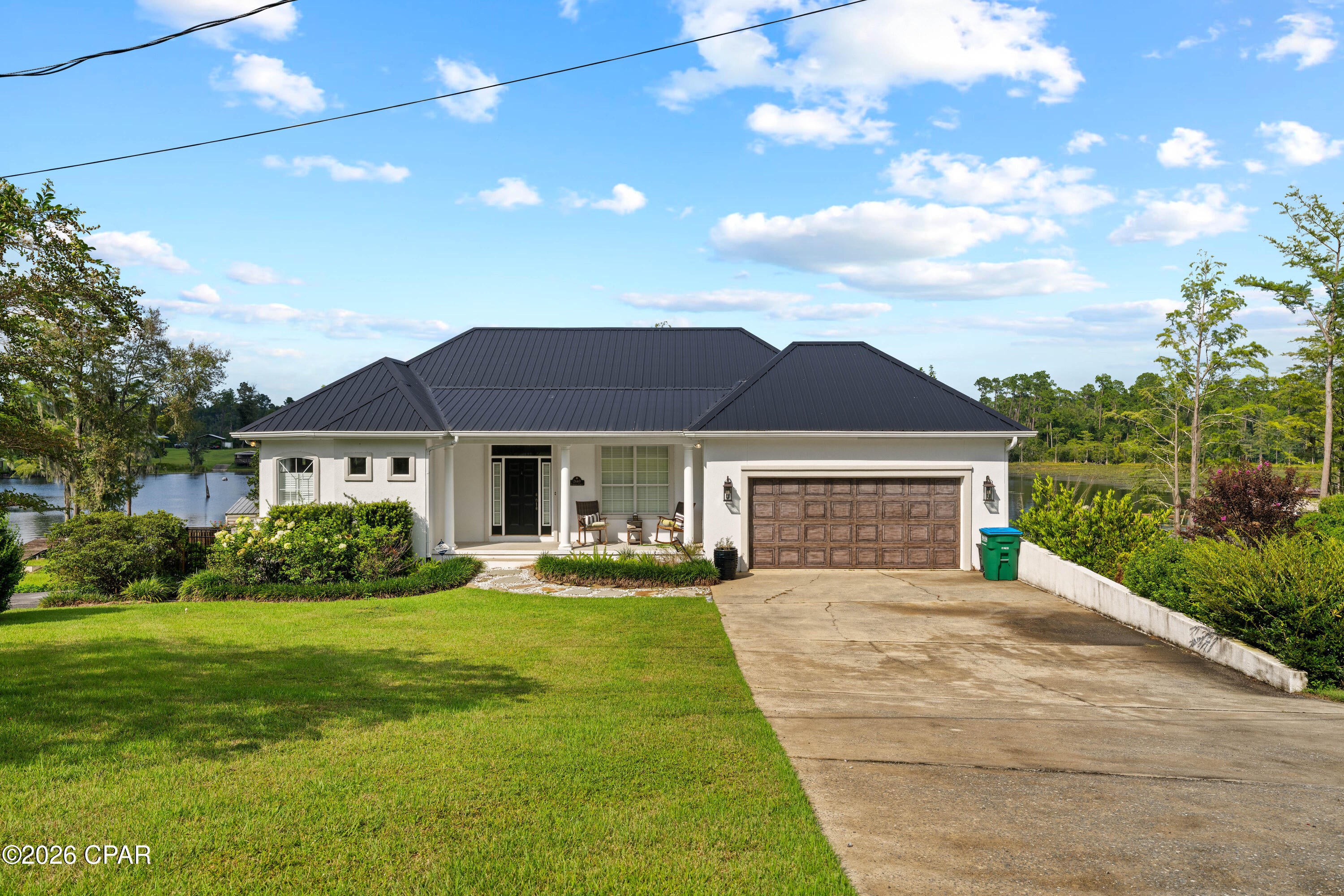 ABSOLUTELY GORGEOUS COMPASS LAKE WATERFRONT HOME! Enjoy lakefront living on beautiful Compass Lake, one of North Florida's premier recreational and ski lakes, offering plenty of room for boating, water skiing, wakeboarding, fishing, swimming, and unforgettable days on the water.

This impressive custom-built home has been beautifully updated and offers breathtaking lake views from the moment you step inside. Spacious rooms, 10-foot ceilings, a grand foyer, custom crown molding, architectural details, elegant columns, and an open living area create a comfortable yet impressive setting for both everyday living and entertaining.

The kitchen features a functional, inviting layout, while expansive views of Compass Lake provide a spectacular backdrop throughout the home. In addition to four bedrooms, the home includes a theater room and wine cellar, giving you even more space to relax and entertain family and friends.

Numerous improvements have already been completed, including a newer metal roof, fencing, seawall, well pump, 120-gallon well tank, A/C unit, refrigerator, bedroom flooring, and blown-in foam insulation throughout the home. New water filtration system.  Two wooden porches were also added along the back, creating the perfect place to unwind and enjoy the beautiful waterfront setting and evening sunsets. Also enjoy a new smart lighting system throughout the house.  

The meticulously maintained landscaping complements the property beautifully. The property also features an exceptional workshop with plenty of room for hobbies, storage, a man cave or she shed.  RV storage on the other side of workshop. 

Whether you're searching for a full-time waterfront residence, weekend lake retreat, or a place where family and friends can gather for years to come, this Compass Lake property delivers the lifestyle you've been looking for. Spend the day skiing and boating, relax on the porch as the sun goes down, and enjoy one of North Florida's most desirable recreational lakes right outside your back door.

This is more than a waterfront home--it's the Compass Lake lifestyle.