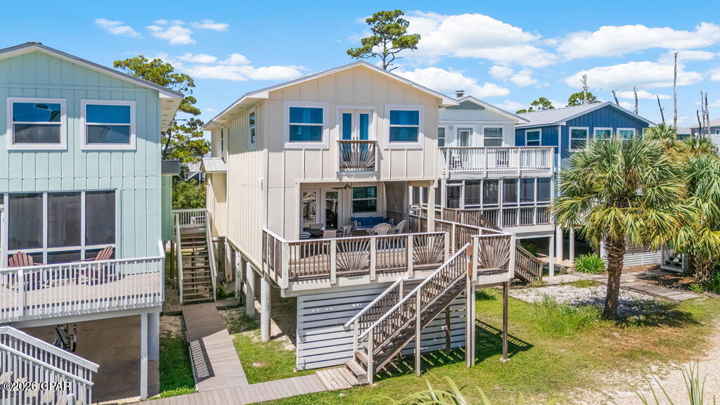 Life is just a little slower on South Cape San Blas, and that's exactly what makes this home so special. Located at 126 Cape Dunes Drive, this 2nd-tier, 3-bedroom, 3-bath beach house offers Gulf views, an easy coastal floor plan, and the kind of relaxed atmosphere people come to the Cape looking for. The open living, dining, and kitchen areas create a comfortable space for gathering after a day at the beach. Coastal-inspired finishes, plenty of seating, and an easy flow make it enjoyable for both quiet weekends and hosting family and friends. The bedrooms are thoughtfully tucked away upstairs, creating a quiet retreat at the end of the day while keeping the main living spaces open for entertaining and spending time together. One of the best parts of this home is the outdoor living space. Step onto the deck to enjoy Gulf views, sip your morning coffee, unwind with an evening drink, or gather around the table while listening to the sound of the waves. With designated beach access just a short stroll away, you'll be on the sand in minutes whenever the beach calls. Cape Dunes is tucked away on the south end of Cape San Blas, placing you close to everything that makes this stretch of the Forgotten Coast so special. Spend your days exploring the 9-mile Loggerhead Run Bike Path, hiking the trails and beaches of St. Joseph Peninsula State Park, enjoying the playground, pickleball courts, kayak launch, and beach access at Salinas Park, or heading over to Scallop RePUBlic for live music and good times with friends and family. Whether you're looking for a weekend getaway, a second home, or simply a place to escape the everyday, this home offers a comfortable place to slow down, unplug, and enjoy everything that makes Cape San Blas one of Florida's favorite beach destinations.