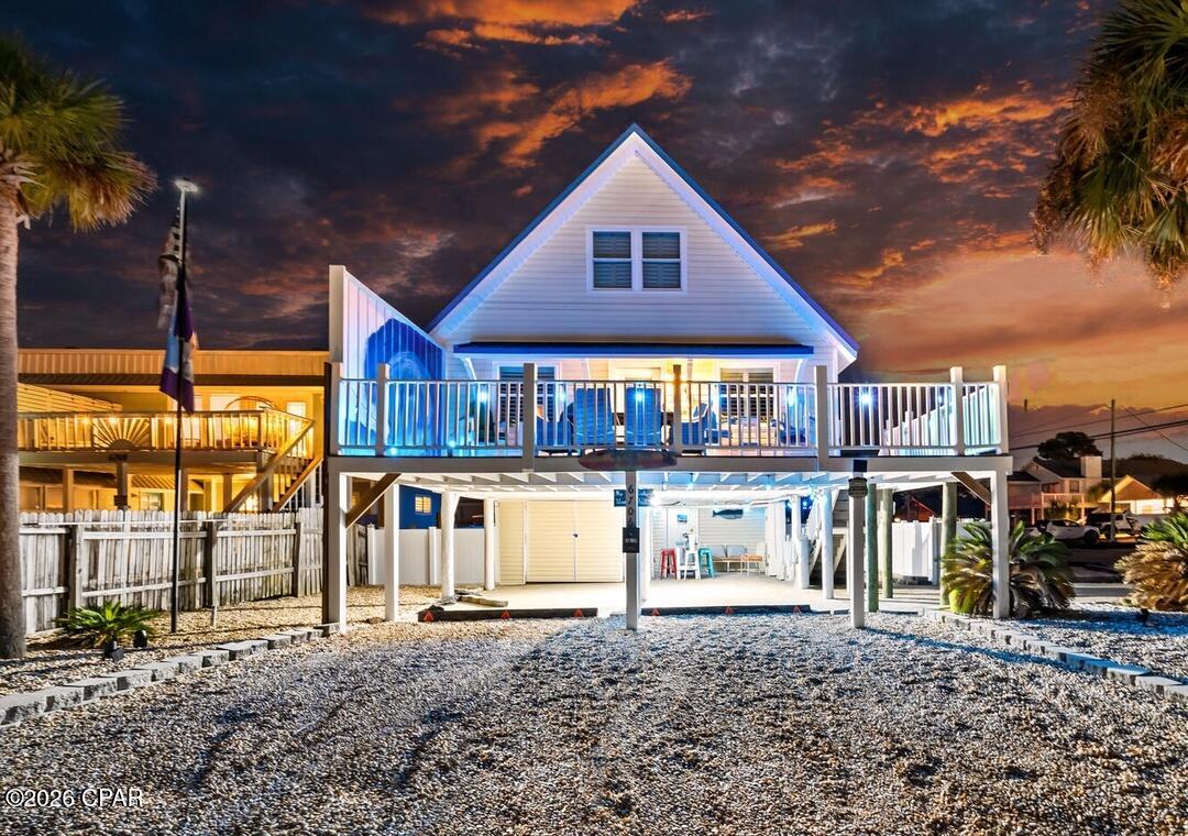 Purchase for 10% down! NO HOA w/ WATERVIEWS! Welcome to Coastal Bliss, where every detail has been thoughtfully designed to create unforgettable moments along Florida's Emerald Coast. Perfectly positioned in one of Panama City Beach's most desirable golf cart-friendly neighborhoods, this beautifully appointed 4-bedroom, 2-bath coastal residence offers the rare combination of luxury, location, and investment potential--all just moments from the Gulf of Mexico.

Situated on an oversized corner homesite, this exceptional property enjoys tranquil lagoon views from the backyard while Public Beach Access #12 is just moments away, placing the sugar-white sand, emerald-green waters, TopGOLF - practically at your doorstep. Whether you're searching for a full-time residence, luxurious second home, or exceptional income-producing investment, this turnkey property is ready to enjoy from day one.

From the moment you enter, you'll appreciate the bright, open-concept design that effortlessly blends sophisticated finishes with relaxed coastal elegance. The spacious living room flows seamlessly into the dining area and beautifully appointed kitchen, creating an inviting gathering space perfect for entertaining family and friends.

At the heart of the home, the chef-inspired kitchen showcases an oversized island, elegant glass tile backsplash, stainless steel appliances, abundant cabinetry, and generous workspace, making every meal feel like a special occasion.

Designed to comfortably accommodate family and guests, the home features four spacious bedrooms. Two beautifully appointed guest bedrooms with queen beds are conveniently located on the main level, while upstairs you'll discover a luxurious primary suite with a king bed alongside an additional 4th bedroom featuring two full-size beds. The thoughtful floor plan comfortably sleeps everyone while maintaining an open, spacious feel throughout.

One of the home's signature features is the expansive second-floor wraparound balcony that surrounds the residence, creating an incredible outdoor living experience. Sip your morning coffee overlooking the lagoon, unwind beneath breathtaking Gulf Coast sunsets, or gather with loved ones as the coastal breeze sets the perfect backdrop for unforgettable evenings.

The outdoor living continues below with a covered furnished patio overlooking the private vinyl-fenced backyard. Designed for entertaining, you'll enjoy a grilling pavilion, relaxing porch swing, fire pit gathering area, and an abundance of green space for games, family gatherings, and outdoor dining beneath the stars.

Coastal Bliss isn't simply a beautiful home--it was created around family traditions. After every incredible day at the beach, ring the home's welcoming bell as you return ''home'' to celebrate another day of making lifelong memories. Before departing for your journey home, ring it once more as a wish for safe travels until your next visit. It's a simple tradition that turns every stay into something truly unforgettable.

Beyond its exceptional beauty, this property offers the convenience every coastal homeowner desires. The oversized corner lot provides ample parking for multiple vehicles, boats, golf carts, and recreational equipment, along with a covered garage measuring approximately 12.5' x 25' and an additional lockable storage area for all your beach essentials.

Boating enthusiasts will appreciate being just blocks from the neighborhood boat ramp, making days on the water effortless. Spend mornings fishing the lagoon, afternoons on the Gulf, and evenings enjoying the area's incredible restaurants, shopping, entertainment, and waterfront attractions--all just minutes from your front door.

Quality craftsmanship and thoughtful upgrades provide lasting value throughout the home, including new ocean-rated impact windows installed within the last 6 years, elegant plantation shutters, a durable metal roof, luxury vinyl plank flooring, and beautifully mai Offered fully furnished (excluding select personal items), this remarkable residence is completely turnkey and ready to enjoy immediately.

Luxury Coastal Highlights
Public Beach Access #12 just moments away
Lagoon views from the backyard
Golf cart-friendly neighborhood
One block to the lagoon and community dock
Three blocks to the Gulf of Mexico
Expansive wraparound second-floor balcony
Covered outdoor living area with television
Fire pit, grilling pavilion, and porch swing
Oversized corner homesite with fully fenced backyard
Boat and RV parking
Covered garage plus additional lockable storage
Ocean-rated impact windows with plantation shutters
Minutes from marinas, waterfront dining, boutique shopping, entertainment, Topgolf, and area attractions

Whether you're enjoying sunset cocktails from the wraparound balcony, spending the day boating on the lagoon, walking to the beach with family, or entertaining guests beneath the stars, Coastal Bliss offers far more than a home--it delivers the luxury coastal lifestyle buyers dream of.

This is a rare opportunity to own an extraordinary beach retreat where every day feels like a vacation and every visit becomes a cherished memory.