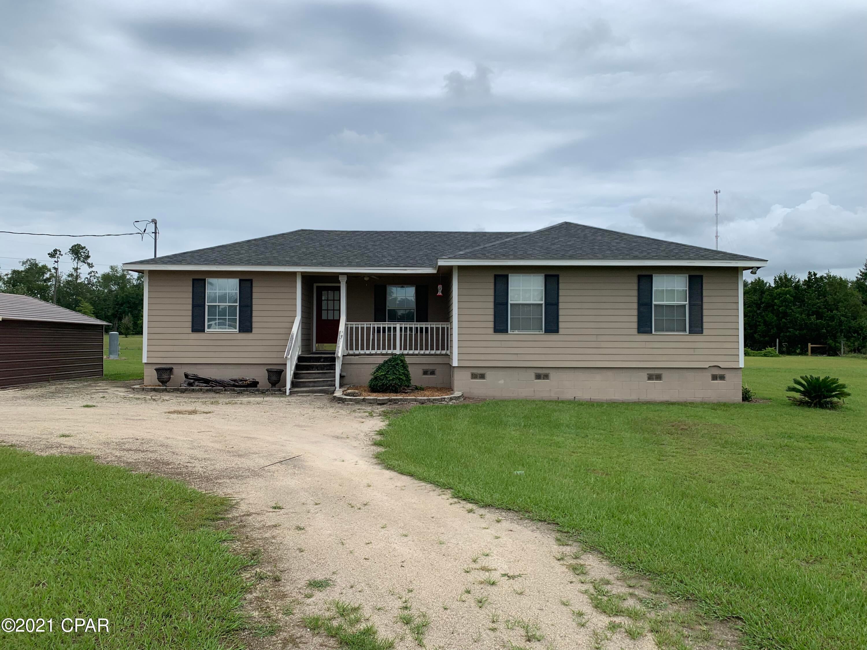 Comfortable 3 Bedroom 2 Bath home on 1.98 Acres in the country.  Not too far off the beaten path with a spacious yard, circular drive, detached carolina carport and a front porch just waiting for a rocking chair.  Features of the home include a new roof, large dining area, and a large master bedroom and walk-in closet.  This home has plenty of storage space and laminate wood flooring in the living room, dining and hallway areas and hardie board siding outside.  Make an appointment today to see all this home has to offer.