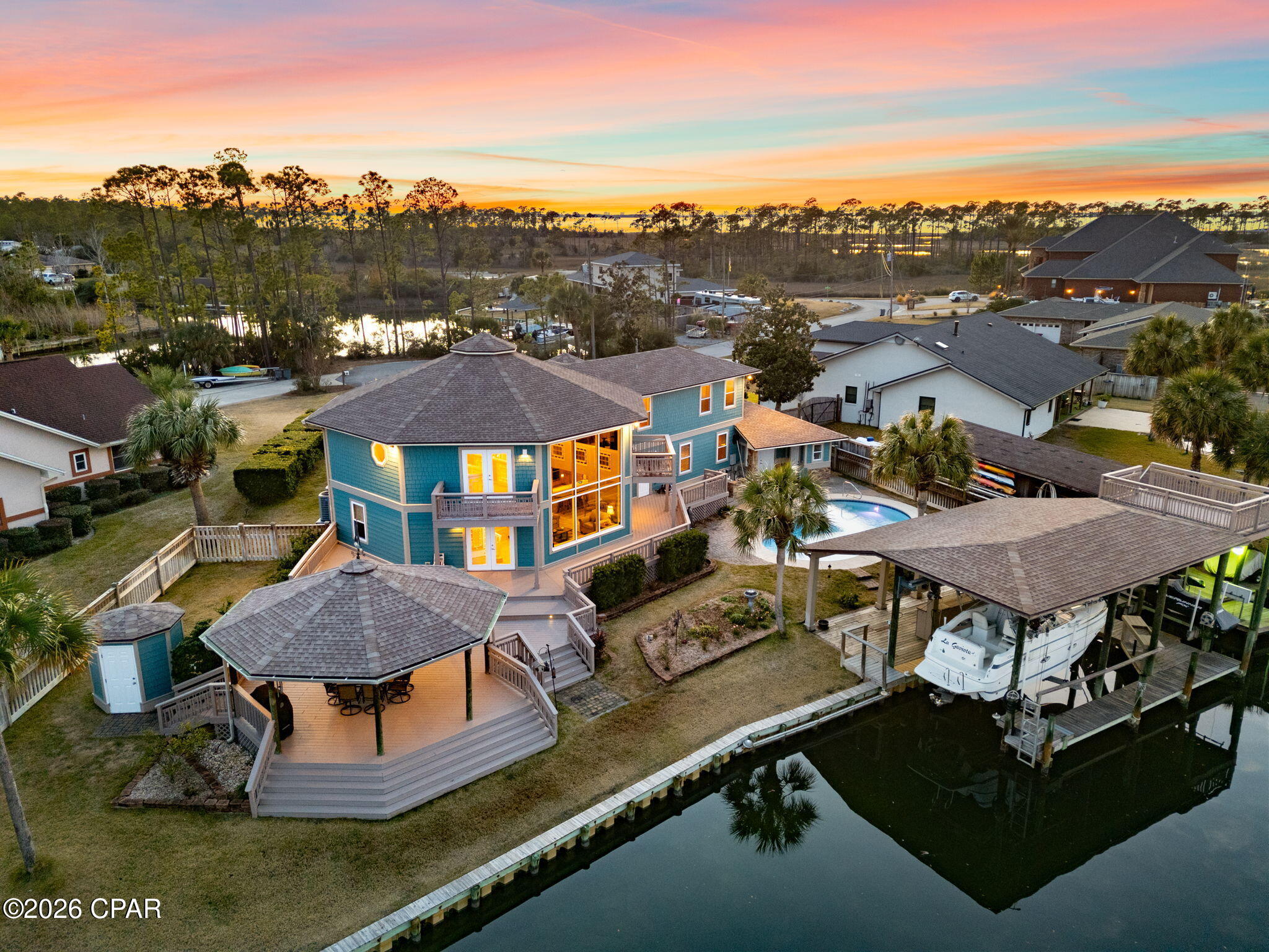 Florida Living at its BEST!!  Breathtaking water views, gorgeous Sunsets, A Boater's Dream. Enjoy Waterfront Living, and make friends with local wildlife!! No HOA - This one-of-a-kind 4 bedroom, 4.5 bath home offers 2 master suites; one on the main level. Each bedroom has its own dedicated bath. The extra large wrap around Loft has 2 Balconies overlooking the Water. The kitchen is a chef's delight, featuring an induction cooktop and double convection ovens and walk-in Pantry. Two main living areas offer lots of options. Hidden Saferoom under the stairs. The home features Loads of Storage. JUST INSTALLED brand new state of the art 16 SEER Trane side discharge heat pump HVAC- keep comfortable for years to come!! But the real attraction is the outdoor space: a Private Pool with spacious deck & Gazebo, a Boat House with 2 Boat Lifts, Fish Cleaning Station, and an Observation Tower! Sunset Lane is a Peninsula  - Come claim your own Private Oasis!