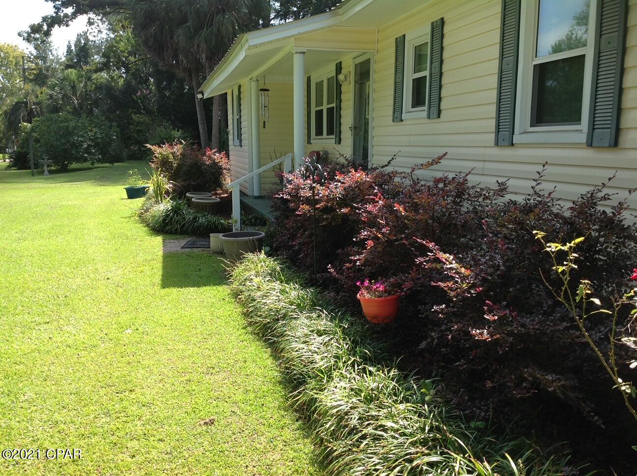 CURRENTLY UNDER CONTRACT SELLER ACCEPTING BACKUP OFFERS. This well maintain 3-bedroom 2 baths home offers a large dining area, large master BR, 26' x 14' screened patio. Lush landscaping, fruit trees and blooming plant. Home is in good condition, some upgrades: Laminate Floors in Living and dining area. Large outbuilding. New tankless Hot Water Heater. Metal Roof. The adjacent lot is available for an additional​​‌​​​​‌​‌​​​​‌​​‌​​​​‌‌ $8000.