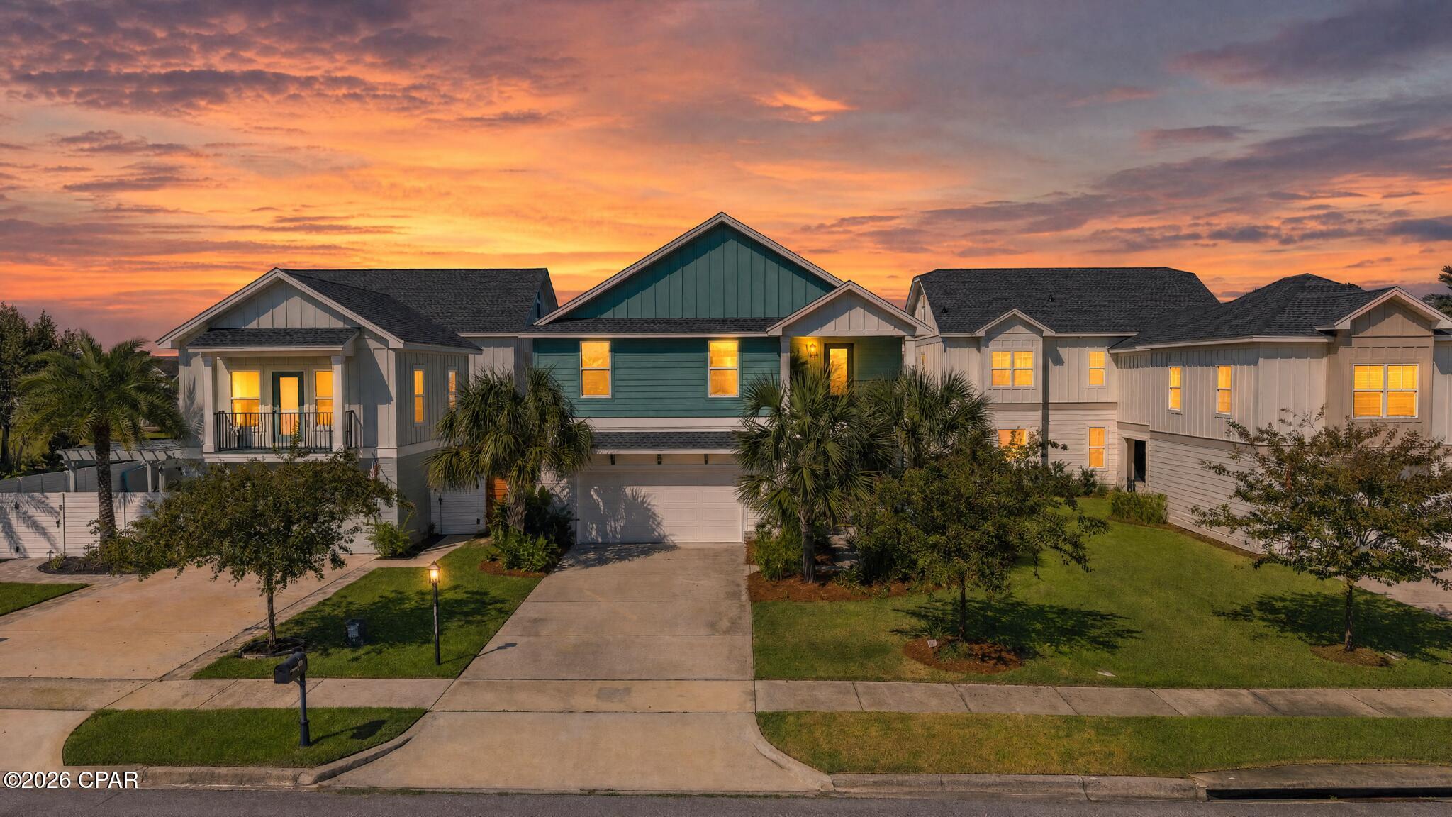 There is so much to love about life in Tapestry Park, and this home puts you right in the middle of it! From golf cart rides to the beach to afternoons at the pool and evenings on the front porch, this neighborhood has such a fun coastal feel while still giving you the space and amenities of a true residential community.

This 2022-built home offers approximately 3,150 square feet with 5 bedrooms, 3.5 baths, two living areas, great storage, and plenty of room to spread out. Even better, it sits directly across from one of Tapestry Park's large green spaces, giving the front of the home an open view instead of looking straight across at another house.

The covered front porch is one of those spots you'll want to actually use. It overlooks the landscaped, fully fenced yard and green space across the street and gives you a great place to enjoy your morning coffee or wind down at the end of the day.

Upstairs you'll find a second living area along with spacious bedrooms, large closets, bonus space, and even a private patio off one of the bedrooms. Whether you need an extra hangout space, office, hobby room, or room for guests, there are plenty of options here.

Downstairs, the open living, dining, and kitchen areas flow together and make the home feel bright and welcoming. The kitchen features quartz countertops, custom cabinetry, stainless steel appliances, upgraded fixtures and lighting, and plenty of room for cooking and gathering. A built-in dry bar with a beverage refrigerator adds another fun spot for entertaining. The primary suite is also located on the first floor.

And then there's Tapestry Park itself. The neighborhood features sidewalks, charming streetlights, underground utilities, ponds with walking areas, green spaces, and plenty of ways to enjoy being outside. Brunswick Hall serves as the community clubhouse and includes gathering spaces, a kitchen and additional amenities. Residents also have access to two community pools, playground, tennis and pickleball courts and basketball courts. 

The community is golf-cart friendly and conveniently located near the beach, Pier Park, restaurants, shopping, schools, and everything else Panama City Beach has to offer. HOA dues include cable, internet, twice-weekly trash pickup, and access to the neighborhood amenities. 

With 5 bedrooms, multiple living spaces, a first-floor primary suite, a fenced yard, a green-space view, and so many neighborhood amenities right outside your door, this home gives you plenty of room without giving up the laid-back Panama City Beach lifestyle.