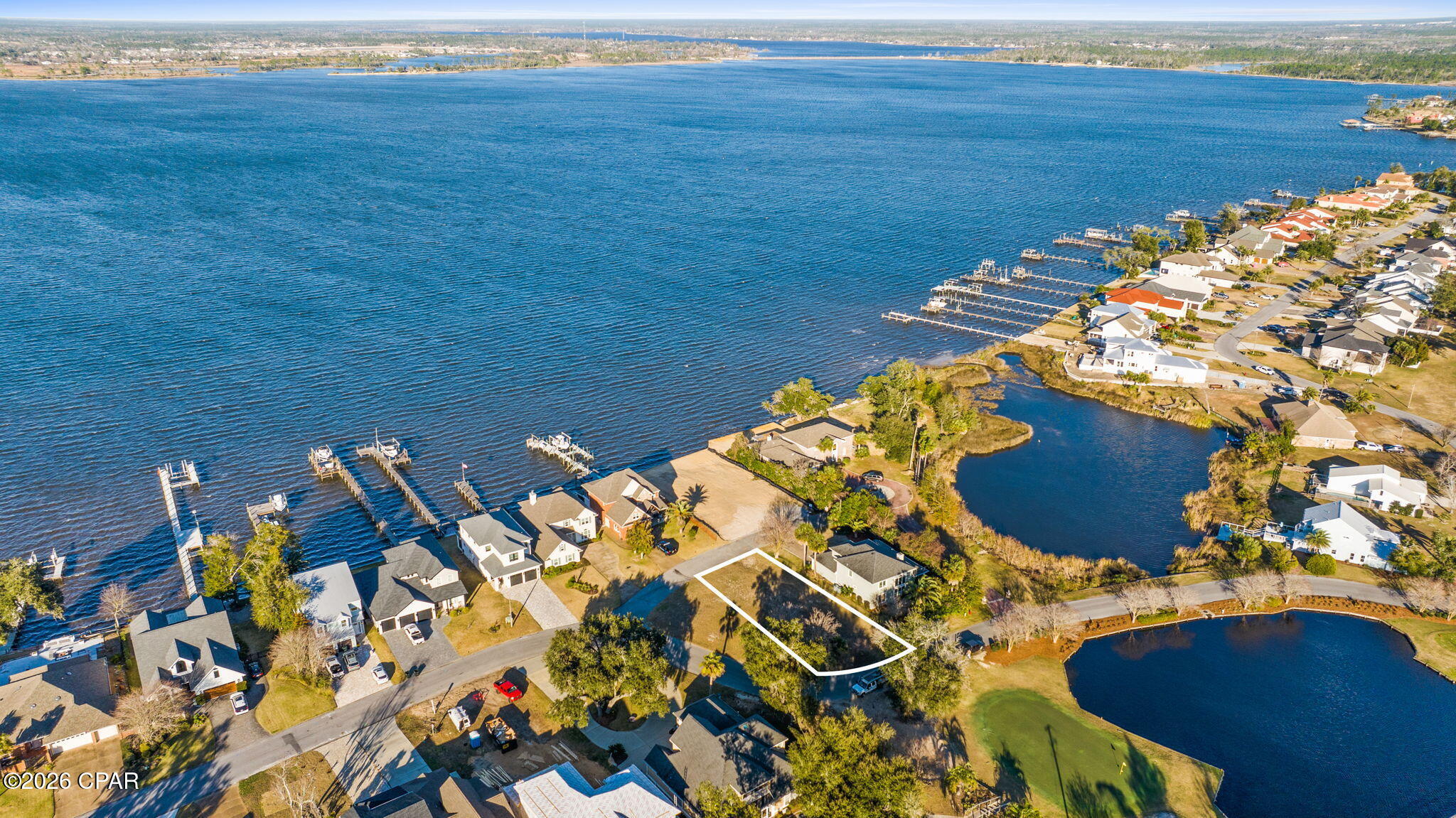 A rare opportunity awaits in Panama Country Club — the ONLY vacant lot currently available in this coveted neighborhood. This premier homesite is ready for your custom new construction, offering the perfect canvas to build the home you've always envisioned.

Wake up to peaceful views of the 7th hole stretching out behind your backyard, while enjoying glimpses of the bay from the front of the property—a unique blend of golf course serenity and coastal charm. Tucked inside an established community, this lot offers privacy, prestige, and an unbeatable setting.

Opportunities like this don't come often. Secure your place in Panama Country Club and bring your dream home to life.