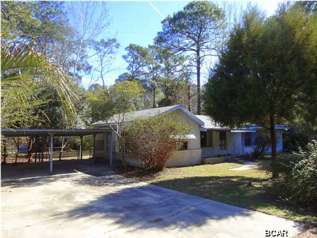 Located just 2 minutes from the Nature Walk Golf Club, this truly unique home is tucked away in a private setting. The house features spacious living room, 3 bedrooms, and 2 full baths, concrete drive with 2 space carport. Enjoy the large den or relax in the approx. 200 Sq. Ft. Florida room that is not included on the heated and cooled square footage. The back yard is totally fenced, three sides are chain link, one side has privacy fence. There is plenty of room to park an RV on the south side of home. The house has a lot of potential. Ready for your personal touches. Age, Square Footage, and room sizes approx., if important please verify.