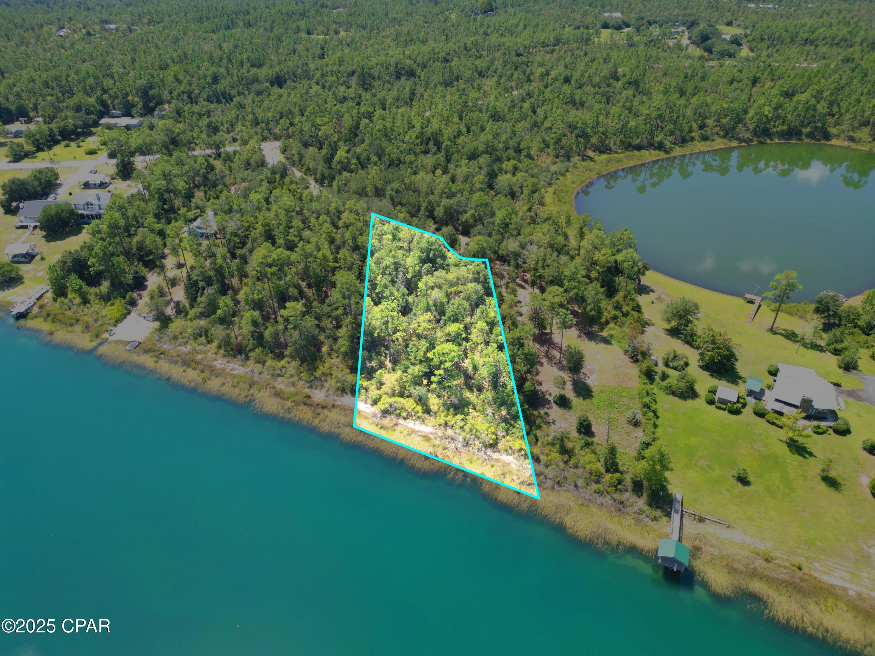 Discover the perfect waterfront retreat on Silver Lake, a hidden gem just south of Marianna and less than an hour's drive to the white sand beaches of Panama City. This large 3-lot parcel offers plenty of space to build your dream home, family compound, or weekend getaway.
Silver Lake is known for its sandy shoreline and crystal-clear fresh water, making it ideal for swimming, fishing, and endless recreation. To preserve its natural beauty, the lake prohibits gas-powered boats—keeping the water peaceful and pristine. Enjoy the quiet with electric motors, kayaks, paddle boards, and canoes gliding across the surface.
Purchase the entire parcel for maximum space and privacy, or choose just 1 or 2 lots at $110,000 each to fit your needs. Either way, you'll enjoy the best of lakefront living with easy access to Florida's Gulf Coast.