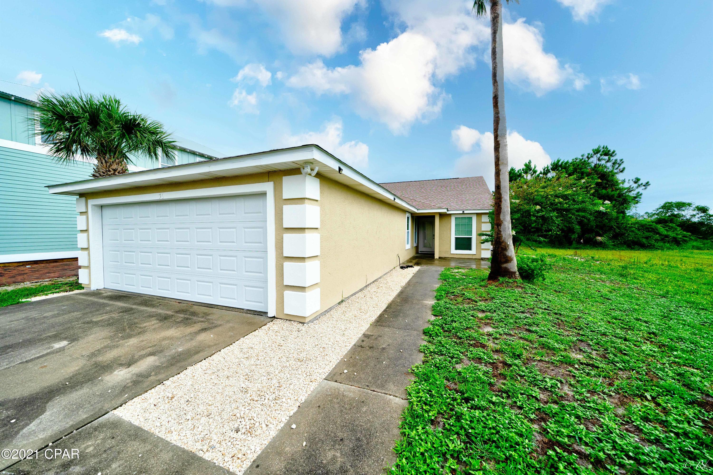 Location! This beautifully renovated three bed, two bath home is just a short walk away from the beach!  Upon entering, you will notice the open concept kitchen with quartz countertops, stainless steel appliances, and a plethora of white cabinets for storage.  The huge living area features recessed lighting, a large arched window to brighten the room, and enough space for a dining area. The master bedroom boasts vaulted ceilings and its own luxurious private ensuite.  The master bathroom features a soaking tub, a double vanity with his/her sinks, and a separate tile shower. The additional two bedrooms share a bathroom that boasts a shower/tub combo with sliding glass doors and plenty of cabinet space. The separate laundry room, with a large utility sink, leads to the two car garage for your convenience. This home has a secluded backyard area with a gorgeous pool and an extended pool deck to enjoy the Florida sun with family and friends. This home is located in a safe and gated community with no traffic.  Enjoy the convenience of being near plenty of restaurants, beaches, and shopping centers; including the well-desired Pier Park area. All furniture is negotiable!