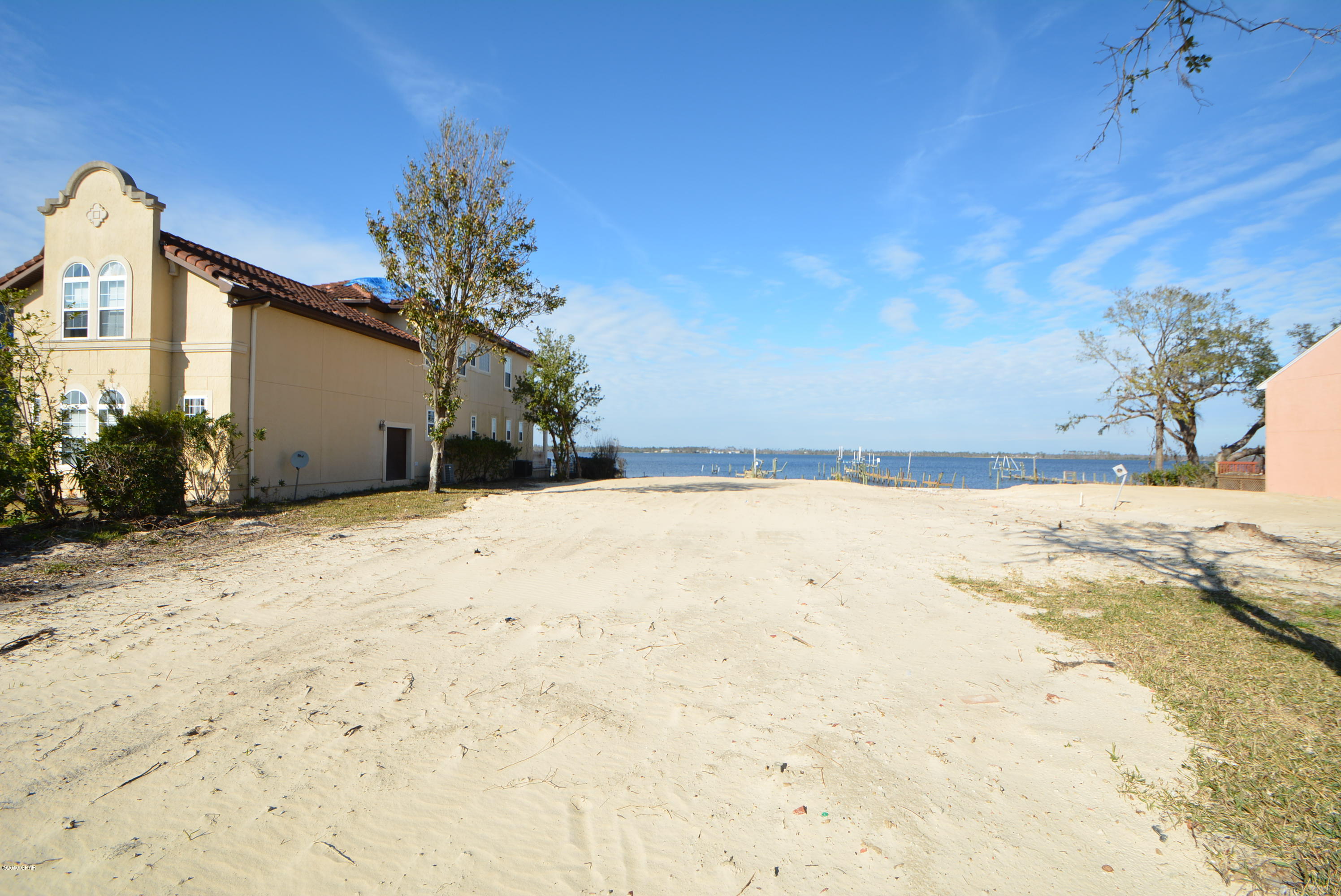 Beautiful sunsets and waterfront living await you on this residential lot in the prestigious Panama Country Club directly on North Bay. Seller has repaired the seawall and dock. Take your boat out fishing in the bay or out for the Lynn Haven fireworks on the 4th of July. The neighborhood is tucked away yet convenient to shopping and the world's most beautiful beaches.