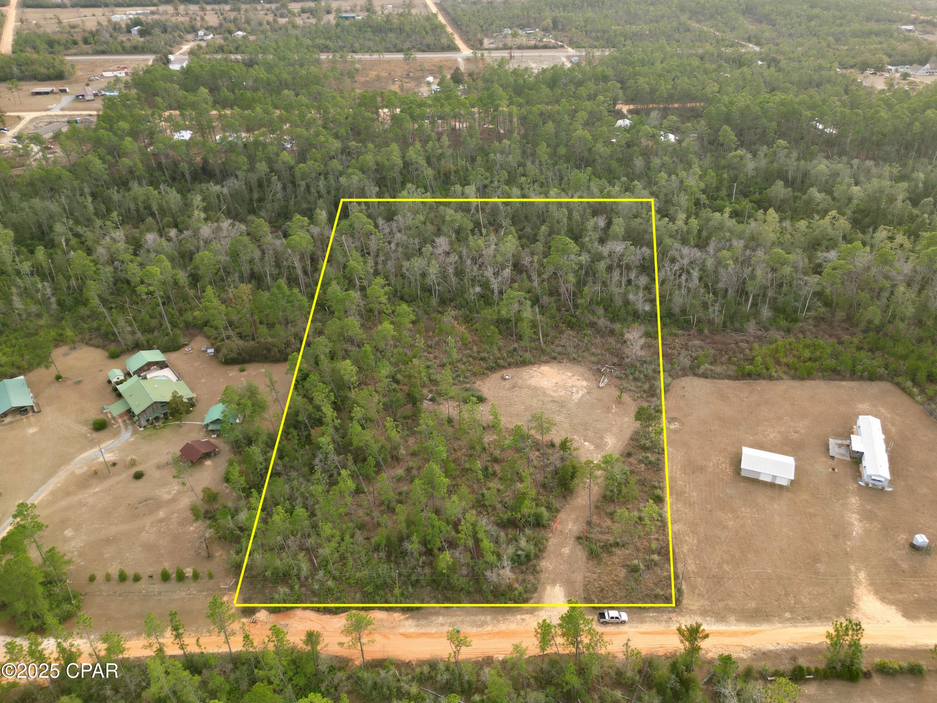 Discover your own slice of paradise with this serene 3.59-acre property, offering the perfect blend of privacy and convenience. Mostly wooded for a tranquil, natural setting, this parcel also features a cleared area with a parking pad ready for your RV. Nestled on a quiet dead-end dirt road, this location ensures peace and seclusion while still being within easy reach of modern conveniences.

Enjoy true country living with the flexibility to build your dream home or place a mobile home on the property. Just a 45-minute drive (MOL) to Panama City and the beautiful beaches, and with easy access north to I-10, this location provides the best of both worlds—rural charm with nearby amenities. Don't miss this opportunity to create your perfect retreat!