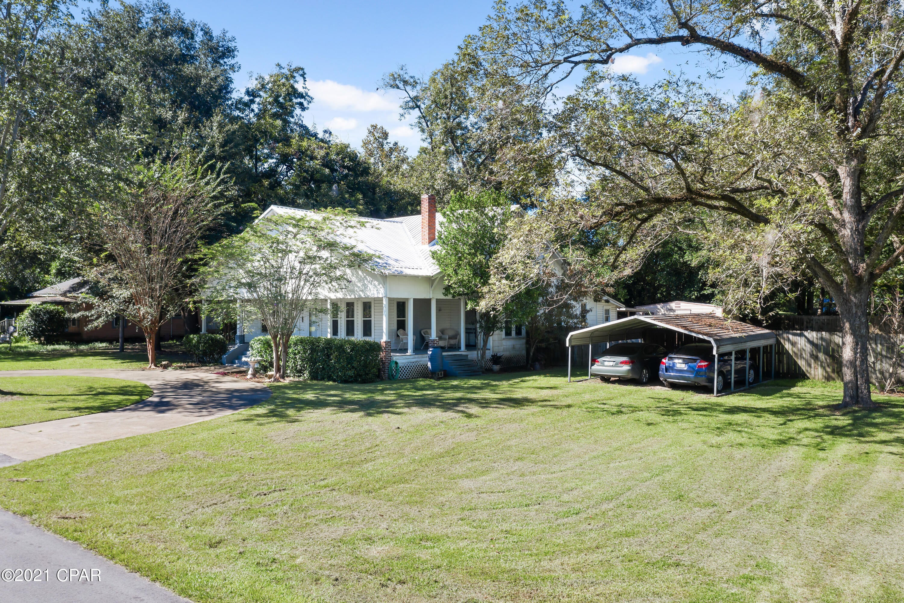 CURRENTLY UNDER CONTRACT SELLER ACCEPTING BACKUP OFFERS 'Take a step back in time with this 5 BR 2 Bath Victorian Southern  Charmer with 10' ceilings! Conveniently located  within the City Limits of Graceville.. An inviting wrap around porch graces the front of the home. There is a circular driveway and covered parking.  This house has a lot of character; built to last. Very spacious and with split bedrooms, 3 on one side of the house and 2 on the other. Central heat and air, HVAC system replaced in 2016, metal roof, new double insulated vinyl windows throughout. updated wiring and plumbing. For additional energy efficiency there are 3 propane gas heaters. Original Claw Foot tub in one bathroom. Fenced back yard, with large shed, and plenty of room for a garden..
