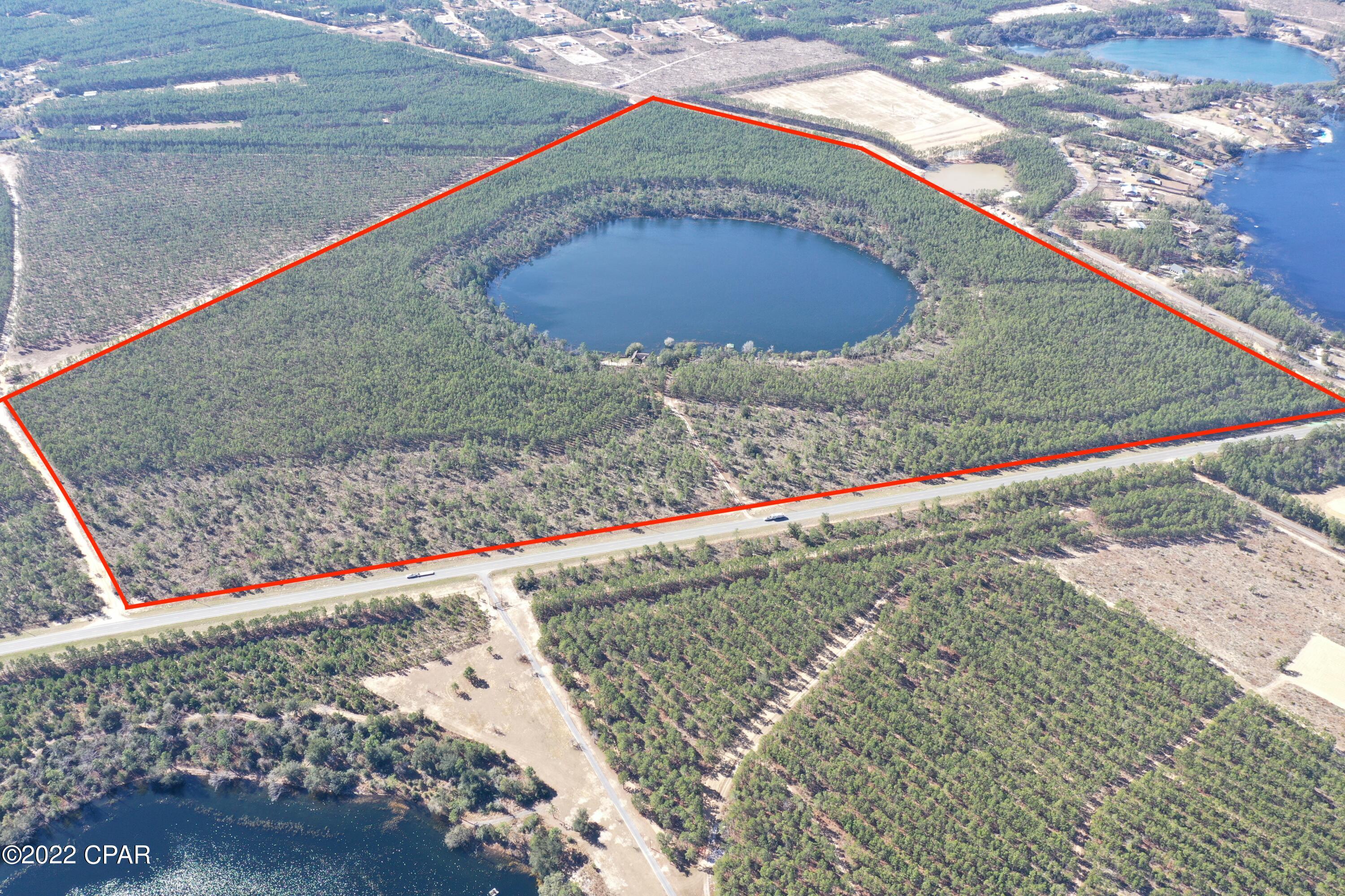 Fully Wooded, High and Dry 160 acres of Land with a private 80' deep,20 acre spring fed lake. Crystal clear water, lots of fish, large Bass and delicious Bream. The property is on Hwy 20, just 1.5 miles east from Hwy 77. Lots of deer, turkey, ducks, squirrels, rabbits, eagles, and fox. This would be a great property for an amazing homesite or family compound with endless recreational opportunities. The property is just 1.5 miles from Hwy 77, 20 minutes from Panama City and 30 minutes from Panama City Beach.