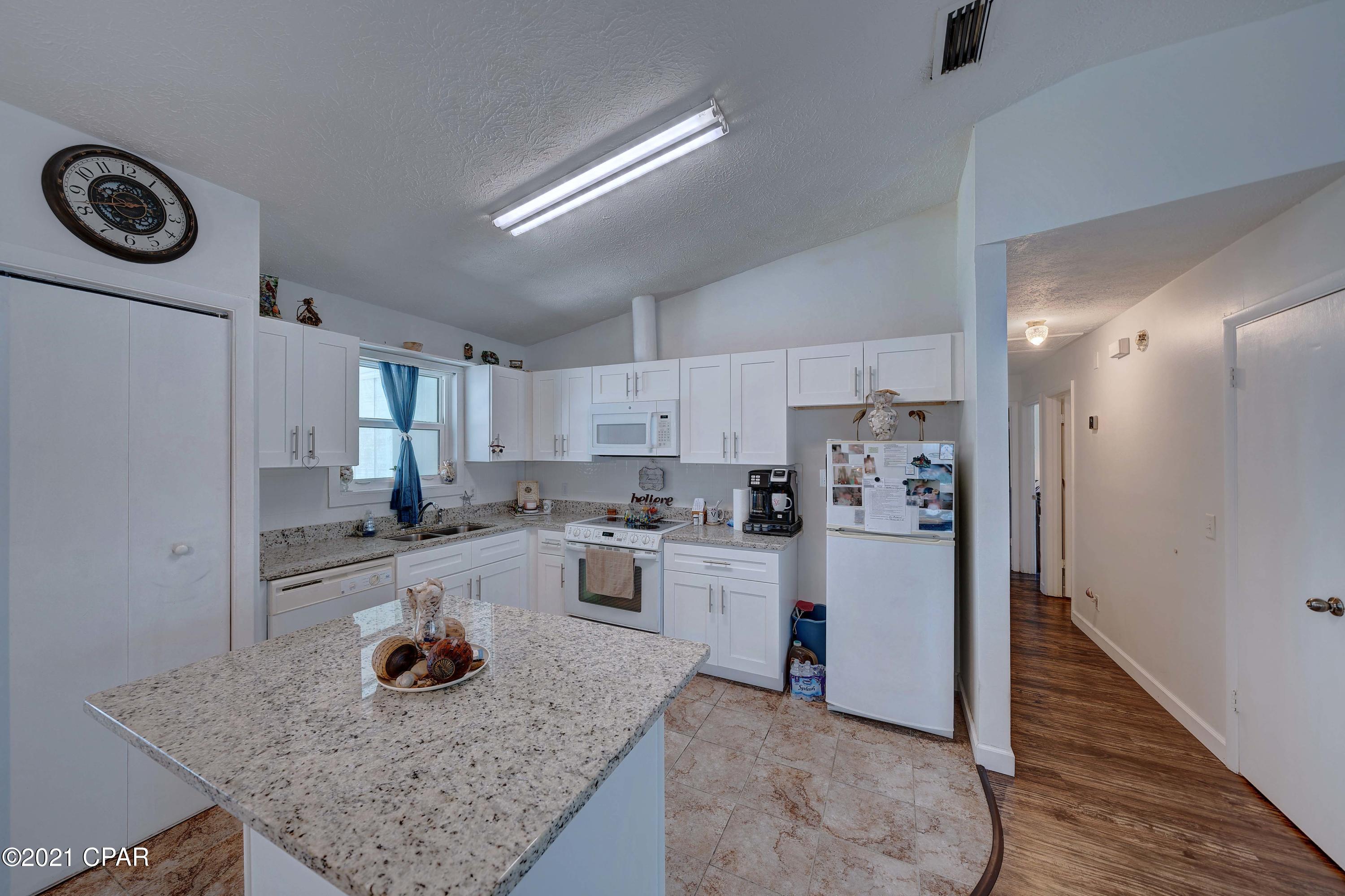 CURRENTLY UNDER CONTRACT...SELLER TAKING BACKUP OFFERS!  Attention boating, diving, fishing and beach enthusiasts! This updated home in the Treasure Island Community is located within a very short distance of two marinas, dive shops, Grand Lagoon and the Pass into the Gulf for the best salt water fishing anywhere and the sandy beach of the Gulf of Mexico. This home is located just a few miles to St Andrew State Park, Schooners, Capt Anderson's, Grand Marlin, J Michaels, Off the Hook and plenty of boat and jet ski rentals. It is right down the street from the Naval Coastal Systems Center and just across the Hathaway Bridge from Gulf Coast State College and The Port of Panama City. This home boasts a ton of updates to include new impact hurricane windows and doors, New 20'x7' attached workshop and covered patio in the very large, privacy fenced backyard. New A/C, new LVP wood flooring, tile in both bathrooms and the kitchen. New granite countertops, new kitchen cabinets, new fireplace inside and out, new closet doors and moldings. No HOA dues in this neighborhood and short term rentals are allowed. Verify measurements if important.