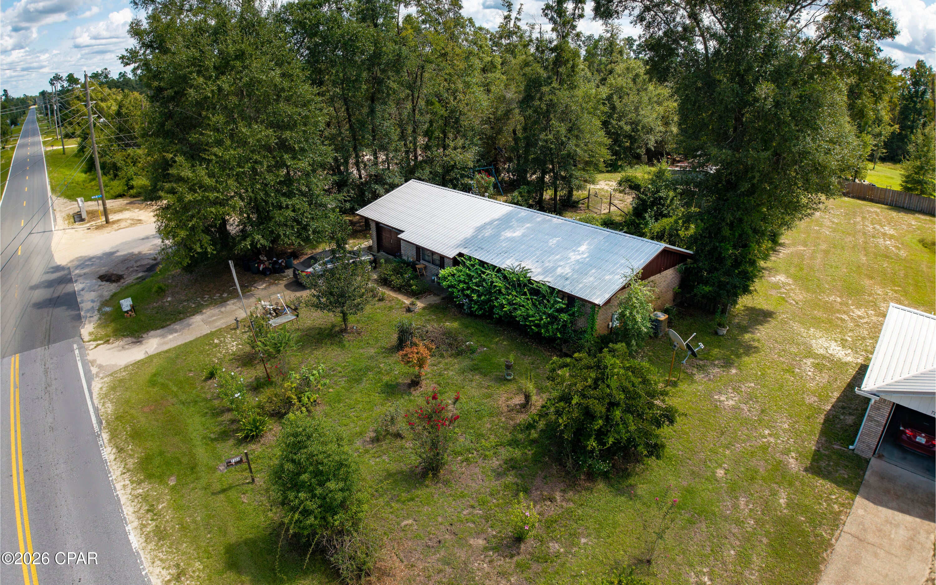 If you're looking for a large, quiet corner lot in the country without sacrificing the convenience of being close to the dining, shopping, and entertainment Lynn Haven and Panama City have to offer, look no further!

This 3-bedroom, 1.5-bath brick ranch with a metal roof offers everything you need to enjoy quiet mornings and beautiful sunsets. Situated on an oversized corner lot with a fenced backyard and detached workshop, there's plenty of room for your toys, hobbies, projects, or extra storage.

Inside, the home features a functional open-concept layout, with the kitchen, dining, and living areas flowing together on one side of the home and the bedrooms tucked away on the other, creating a nice separation between the main living and sleeping spaces.

The home is move-in ready but offers plenty of opportunity for cosmetic updates and personal touches, making it a great option for a first-time buyer, someone looking for a home they can make their own, or an investor looking to add to their portfolio.