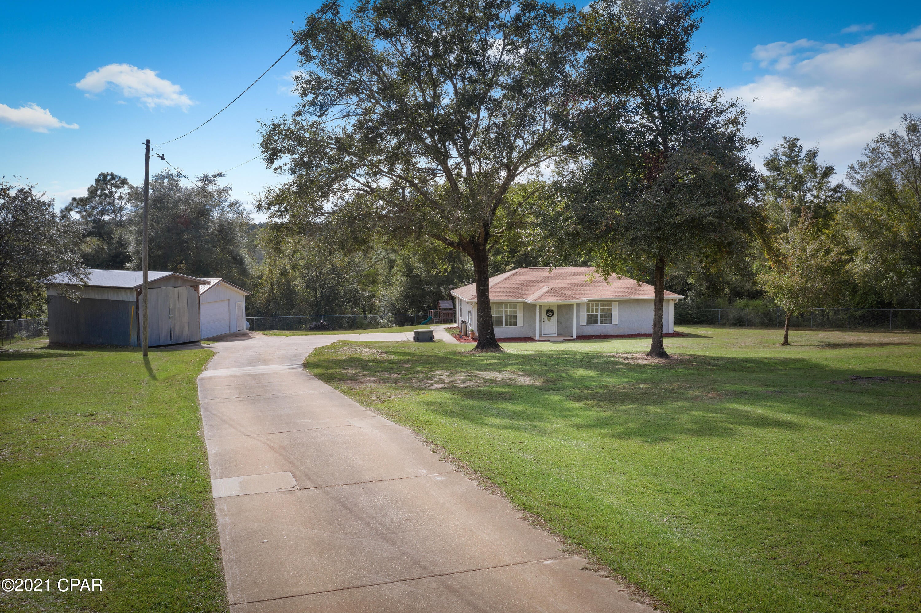 Cute 2 bedroom, 2 bath home sitting on over 4 acres. with approximately 1 acre in fenced in with electronic gate. Home has newer roof, ac and so much more, The property includes whole house generator, water softener, irrigation. 2 car detached garage along with oversized workshop perfect for a boat.