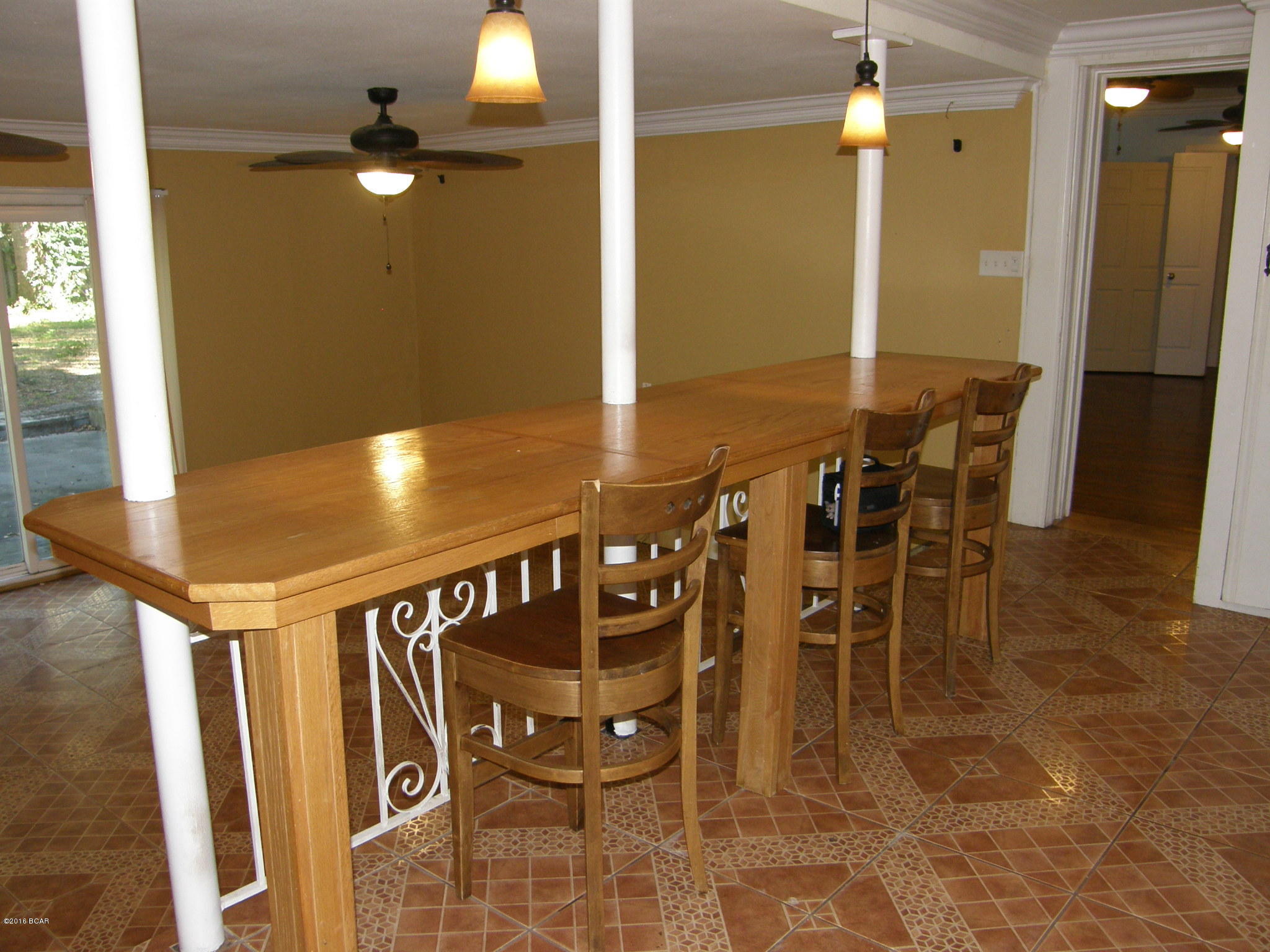 REDUCED! CHARMING 3 BEDROOM, 2 BATH CASSIC COVE HOME WITH SWIMMING POOL NESTLED IN THE COVE AREA WITH BEAUTIFUL OAKS AND PALM TREES. Close to downtown and restaurants. Yacht club, bay, and walking park nearby.  THIS LARGE 2500 +SF is a 2 STORY STURDY BRICK AND BLOCK HOME.  House has undergone lots of updating over the years.  Bonus room upstairs with balcony over pool could be bedroom, game room, or office. Huge bathroom at bottom of stairs featuring a Jacuzzi tub, separate shower and 3 sinks.  Original hardwood floors in living room, dining room, hall, and bedroom.  Terrazzo color tile flooring makes for maintenance free living.  One nice feature is the long breakfast bar overlooking the Great Room. Laundry room and mud room opens into the pool area.  (Could install another bathroom or shower for pool).  Breakfast nook joins the kitchen area to front of home & a long breakfast bar overlooks a step down den & pool area.  Converted garage is bedroom with door out into pool area.  Plumbing and sink in this room which would accomodate another bath room for this converted bedroom. Stainless steel Refrigerator with modern french doors.  3 electric boxes and 2 water heaters.  Living room has nice size fireplace.  Typical Cove home with tons of storage and built in cabinets.  Pool has new motor in pump.  HOME WARRANTY PROVIDED by Seller.