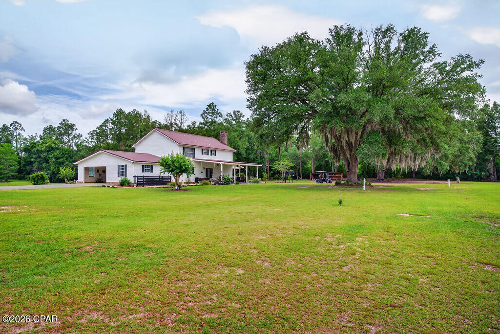 Escape to the beauty of country living with this charming two-story home nestled on beautiful acreage beneath majestic oak trees. A picturesque pond enhances the peaceful setting, creating the perfect backdrop for relaxing and enjoying nature.

Designed for both comfort and entertaining, this home features a welcoming wrap-around porch where you can drink sweet tea and overlook the pond and sprawling landscape, evening sunsets, and the gentle sounds of the countryside. Inside, spacious living areas offer plenty of room for family and guests, while large windows showcase scenic views of the surrounding property.

Step outside to a large patio, watch the sun rise while enjoy morning coffee.  This patio is ideal for hosting gatherings, grilling, or simply unwinding.    Whether you're enjoying the shade of the mature oaks, watching wildlife, or spending time with friends and family outdoors, this property offers a lifestyle that's hard to find.

With ample acreage for recreation, gardening, animals, or future expansion, the possibilities are endless. Combining privacy, natural beauty, and outdoor living at its finest, this exceptional property is ready to welcome you home.

Schedule your private showing today and discover the charm and tranquility this one-of-a-kind property has to offer.