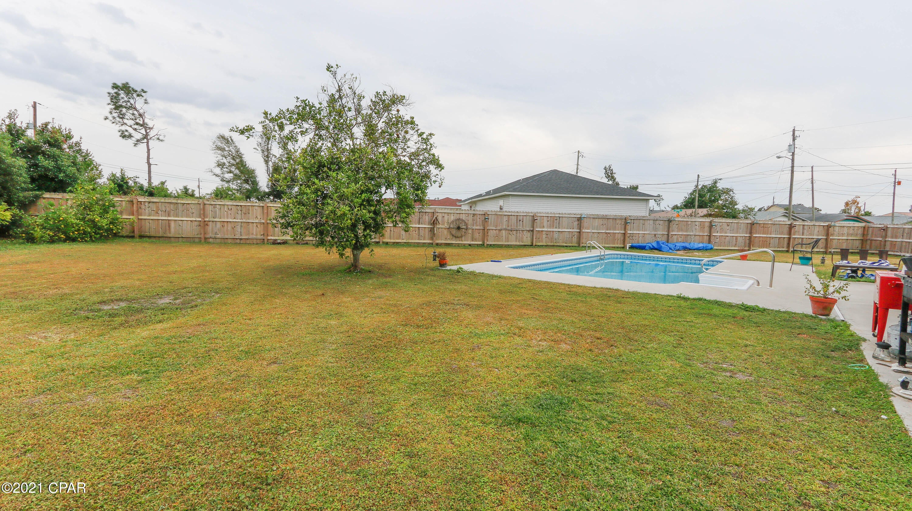 UNDER CONTRACT - This 3 bed 2.5 bath home is an all Brick home with concrete block behind the brick. It  sits on almost half an acre within 12 minutes of Tyndall Air Force base and 30 minutes to the beaches of Panama City Beach.  It has a large totally fenced in yard and a new inground pool with a gas heater and filter less than a year old.  The kitchen has lots of counterspace, High ceilings in livingroom area and while the bedrooms are not huge  2 of the bedrooms have walkin closets. Home has all new vinyl laminate floors through out and new vanities in bathrooms. New roof in 2019 and new HVAC and Hot water heater 2020. There is just some finishing up with the paint before the Seller says ''lets move.''   One of the best priced homes in the area for the square footage and lot size.