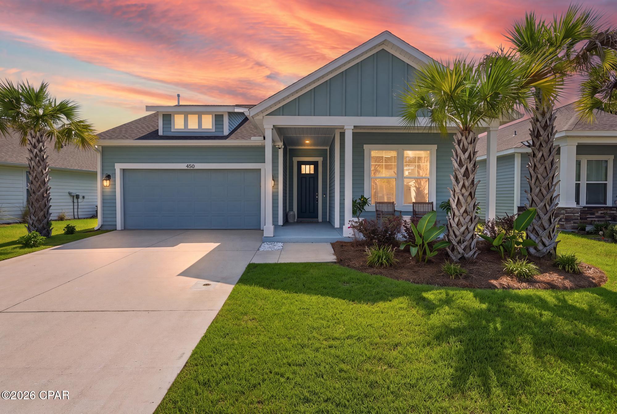 Built in 2021 and meticulously maintained by its original owner, 450 Locksley Drive presents an exceptional opportunity to own a move-in-ready home with one of the community's most desirable upgrades--a private heated pool--in the highly sought-after Breakfast Point community of Panama City Beach.

Offering over 1,600 square feet, this thoughtfully designed residence features three bedrooms, two bathrooms, and a functional split-bedroom floor plan that balances everyday comfort with effortless entertaining. Natural light fills the open-concept living spaces, while warm luxury vinyl plank flooring, tray ceilings, and upgraded designer lighting create an inviting atmosphere throughout.

At the heart of the home, the kitchen has been beautifully enhanced with Crystal Quartz countertops, a tiled backsplash, soft-close cabinetry with upgraded hardware, under-cabinet lighting, and abundant workspace overlooking the dining and living areas--making it equally suited for casual mornings or hosting family and friends.

Privately positioned at the rear of the home, the primary suite offers a peaceful retreat overlooking the backyard oasis. Tray ceilings add architectural character, while the ensuite bath features dual quartz vanities, a beautifully tiled walk-in glass shower, a spacious walk-in closet, and direct views of the pool.

Two generously sized guest bedrooms are situated at the front of the home and share a well-appointed full bath with a tub and shower combination, offering comfortable accommodations for family or visitors.

Additional thoughtful upgrades continue into the laundry room, where butcher block countertops, floating shelves, and additional  cabinetry with upgraded hardware provide both style and functionality. Mini-louver blinds enclosed within the rear patio doors offer a clean, low-maintenance design with convenient light control.

Step outside to discover what truly sets this home apart. The private heated, saltwater pool with a sunshelf creates a resort-inspired backyard rarely found within Breakfast Point, providing the perfect setting to relax after a day at the beach or entertain guests year-round. The fully fenced backyard offers additional privacy, while the attached two-car garage includes built-in storage shelving for added convenience.

Ideally located just minutes from the sugar-white beaches of the Gulf of Mexico, Pier Park, Publix, restaurants, shopping, and everyday conveniences, Breakfast Point is one of Panama City Beach's most desirable neighborhoods, offering sidewalks, community green space, and access to highly rated Breakfast Point Academy.

Whether you're searching for a primary residence, second home, or coastal retreat, this like-new property offers the rare combination of modern construction, thoughtful upgrades, an exceptional outdoor living space, and an unbeatable location..