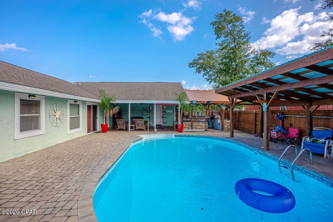SELLER FINANCING FULLY FURNISHED,  NO BANKS INVOLVED , at a 5 year balloon and 25% down.  Monthly payments $2400 monthly (PITI, Taxes, Insurance). The original loan can also be assumed at 2.28% within the 5 year balloon.  Great opportunity as a primary or investment rental home. Turn key, fully furnished.  Take a look at this beautiful home with 4 bedrooms, 2 full baths, large kitchen, office, in-ground pool, fire pit and 2 car garage.  You also have a large laundry room and custom water  softener  Home sits on a corner lot with an additional lot/area for RV parking, and fire pit.   The interior of home has a split bedroom and custom office which can be a 4th bedroom. Plenty of cabinetry and island/breakfast bar.  Exterior of home has a custom outdoor gourmet  kitchen with fridge, grill, and sink, paved custom patio flooring throughout. Sprinkler system on well, tankless water heater,  and fully privacy fenced in with a roll gate to park your RV and extra driveway.  Large in-ground pool, cabana, and outdoor shower.  This home is great  for entertainment, close to Tyndall AFB, beaches and restaurants.  Fully furnished and turn key for VRB or Air BB. Dont miss out on this great opportunity on this home.  Available to show starting Sept. 25 (friday).  All measurements and information must be verified by Buyer or Buyers Agent.