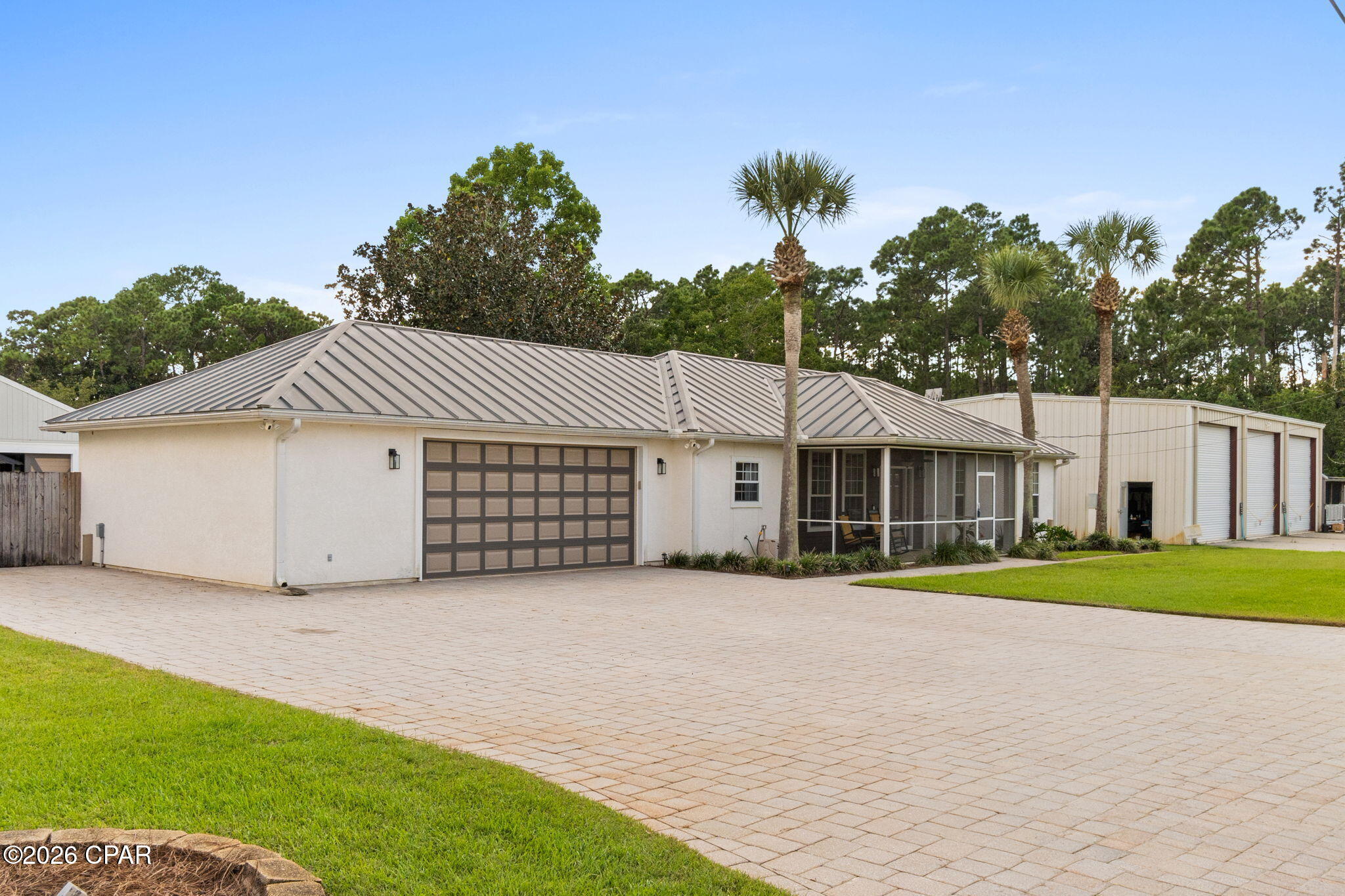 Welcome to 8341 Hand Street | Panama City Beach, FL Offered at $800,000 Lot Size: 0.723 Acres | Total Area: 5,506 sq. ft. (1,750 sq. ft. heated main home) Property Overview An investor's dream and a rare coastal find! Custom-built in 2000 by Bennie Moore, this unique one-of-a-kind estate is situated on over 0.7 acres and located just 8-10 miles from the beach. Featuring paid-off solar panels ($70,000 value) for incredible energy efficiency, multiple outbuildings, and built-in income potential, this property offers unmatched versatility and outdoor charm. Main Residence & Outdoor Features Bedrooms/Bathrooms: 3 Bedrooms / 2 Bathrooms Square Footage: 1,750 sq. ft. custom-built layout Garage Bonus Room: Extra bonus space built into the garage structure. Porch & Paver Details: Front screened-in porch (8.2' x 20.7') perfect for relaxing. Custom pavers wrap seamlessly from the front driveway around to the back of the house and pool, running all the way through to the Koi pond building. Outbuildings & Highlights Screened-In Koi Pond Building: Fully screened-in and features integrated lighting for evening enjoyment alongside a tranquil fountain. Pool House & Theater Area (~2,000 sq. ft.): Includes 1 full bath/shower and a dedicated theater area--ideal for entertaining or guest accommodation. Metal Building (2,700 sq. ft.): Features a small loft, toilet, and sink--making it ideal for a workshop, vehicle/boat storage, or hobby space with convenient facilities. Storage Shed (400 sq. ft.): Built on a solid concrete foundation. Equipped with its own 1 bath + shower. Income Potential & Added Value Turnkey Rental Income: Currently rented out for $3,000/month ($36,000/year) through July 14, 2027--a ready-made stream of revenue for investors! Solar Power System: Fully paid-off solar panel system valued at $70,000, drastically cutting utility costs. Location Highlight: Enjoy peaceful, spacious living on nearly three-quarters of an acre while staying just 8-10 miles away from the world-famous white sandy beaches of Panama City Beach!