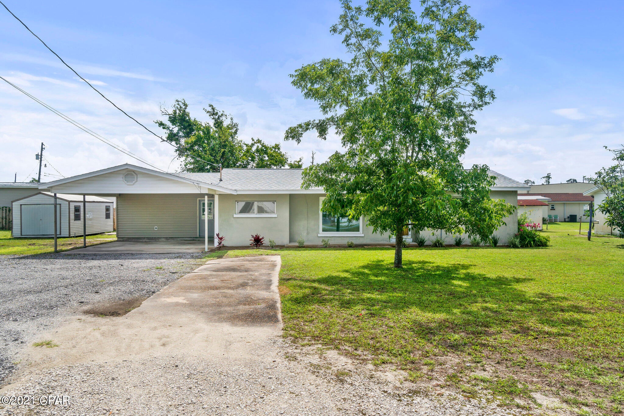 Awesome 3 bedroom 2 bathroom home with so much character! This home sits on a double lot, offering plenty of room for parking any recreational vehicles. Two car carport leads you into a nice mudroom and Florida room. Large living area with formal dining room vinyl plank flooring throughout main living areas. Open kitchen with gorgeous original wood cabinets, breakfast island bar, cook top and wall oven, and counter and cabinet space in abundance! Roof replaced in 2019! Freshly painted. Quarterly pest service through Davis Exterminators.