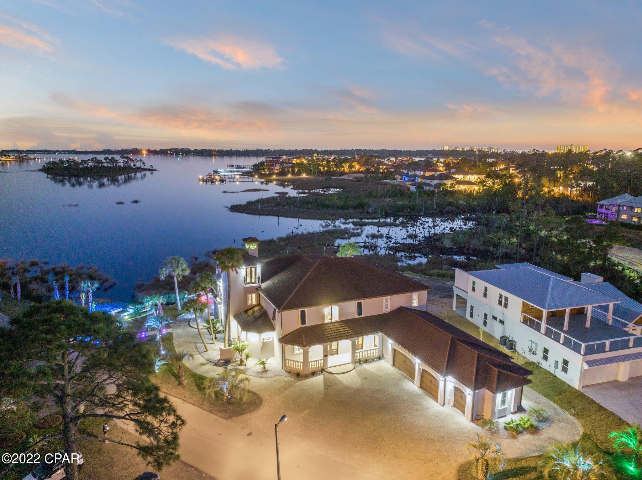 **ELEVATOR INCLUDED AND DEP & USACOE DOCK PERMITS IN PLACE** Featuring over 6,300 sq. ft., this impressive waterfront estate is a highlight of the exclusive Bonefish Pointe within Bay Point in Panama City Beach, FL. and MUST be seen in person to be appreciated. An incredible remodel was just completed in 2022 by a builder from the Washington D.C. area who pulled out all the stops. Starting outside, the outdoor living space is incredible. Boasting incredible lighting, impressive deck space, multiple fire pits and seating areas, an amazing pool and hot tub, bar and plenty of covered area, you can easily host gatherings of 300 people or more..all while overlooking the stunning, expansive water views. Inside, enjoy these same phenomenal views from almost every room. Beautiful travertine floors highlight the gorgeous, large formal living and dining rooms. The primary suite is secluded on the first floor for privacy and boasts a large soaking tub and separate shower in the bath with plenty of space throughout. Enjoy a game of pool or sip a cocktail at the bar in the second floor recreation area...an impressive space overlooking the first floor with access to the second floor balcony. After relaxing here, take a few steps down to the 12-person theater to take in your favorite movie and a bowl of popcorn. The third floor features a bonus room that could be an office, exercise room or bedroom...again with wonderful views of the water. Back on the first floor, you will find everything you need in the massive kitchen including a prep area, wine cellar, wine fridge, expansive island and more. Park four vehicles and a golf cart in the garage and easily fit 10 vehicles or more in the driveway. **New Roof in 2018, New A/C units, the pool has been redone with a new pool heater and a new pump installed. The exterior of home has been re-stucco-ed with new gutters, new railings, new pavers and all new landscaping. The house has all new custom lighting throughout the house and all new hardwood flooring on the 2nd and 3rd floor** Rental projections attached. Make an appointment today to view this awesome estate.