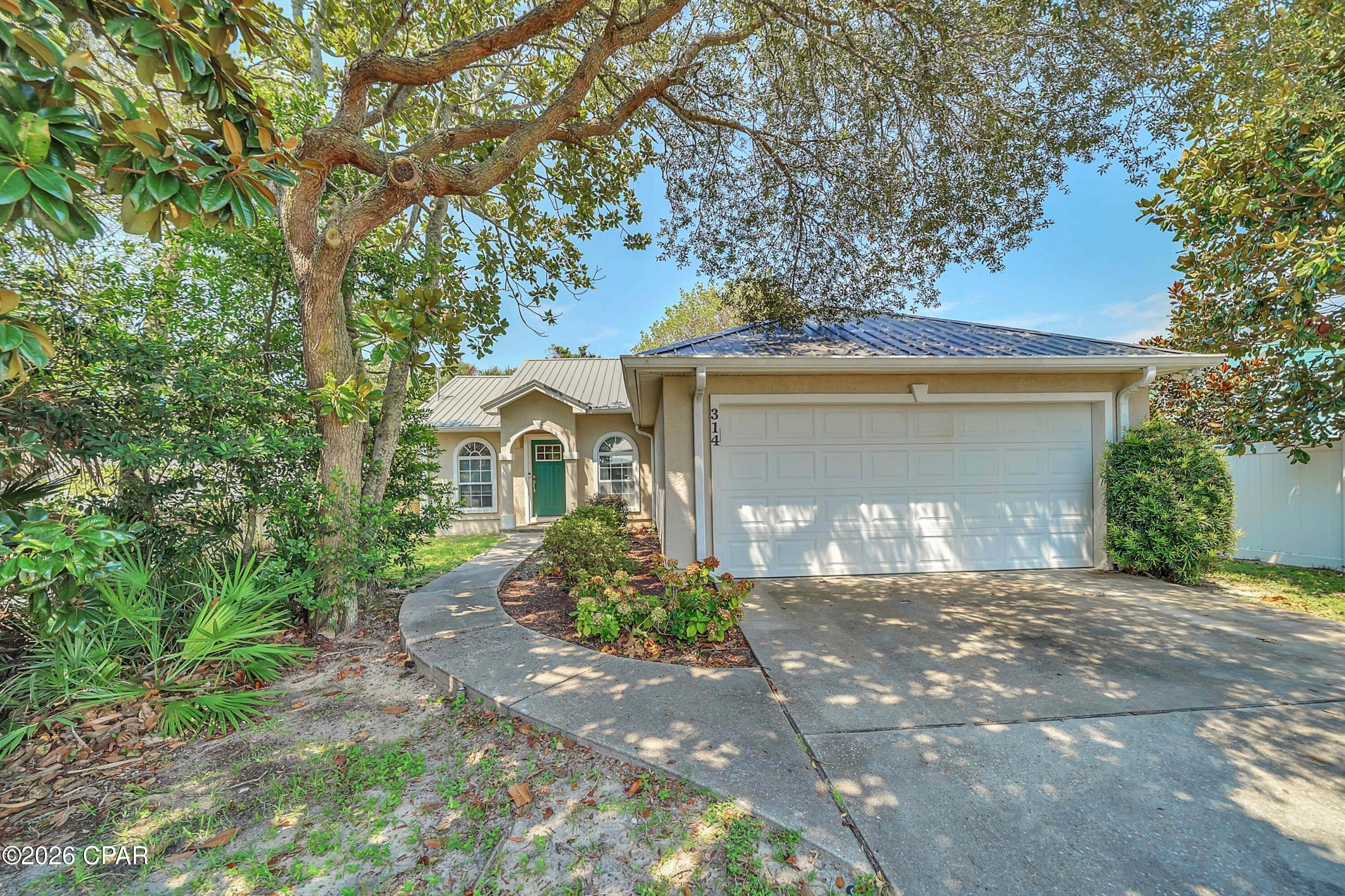 'CURRENTLY UNDER CONTRACT, SELLER WILL CONSIDER BACKUP OFFERS' Welcome to 314 Sundial Street, tucked away on the quieter west end of Panama City Beach. The home is just 0.2 miles from the Gulf of Mexico, between public Beach Accesses 69 and 70, and convenient to many amenities. Pier Park is only 2.2 miles away for dinner, shopping, and nightlife, and Scenic Highway 30A--with its coastal charm and extra stretch of coast--is about a 15-minute drive.
This well-maintained home includes an updated metal roof, a tankless water heater, a new HVAC system, luxury vinyl plank flooring, and stainless kitchen appliances. Enjoy quiet mornings or evenings on the covered, screened deck, plus a large patio for entertaining in the private backyard, which is framed and shaded by mature trees. Whether you are looking for a primary residence, a second beach home, or a short term or long term investment property, this home delivers: no HOA, easy beach access, and nearby amenities.