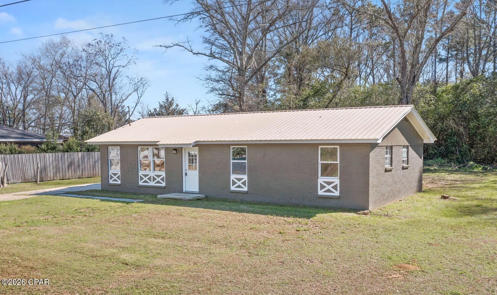 Beautifully renovated and completely move-in ready, this 3 bedroom, 1.5 bath home in Graceville, FL offers modern updates throughout with a clean, fresh feel from the moment you walk in. Inside you'll find new flooring and fresh paint throughout, creating a bright and inviting space. The fully updated kitchen features brand new cabinetry, gorgeous butcher block countertops, a stylish tile backsplash, and updated plumbing and lighting fixtures -- perfect for everyday living and entertaining alike. Both bathrooms have been thoughtfully upgraded with new vanities, toilets, fixtures, and lighting. The full bath showcases a beautifully tiled shower, while the master bedroom includes a convenient private half bath. Major improvements provide added peace of mind, including a new HVAC system (inside and out) installed in 2024, 2025 hot water heater, plumbing fixtures, and interior and exterior doors. This home blends small-town charm with modern finishes already completed for you. Whether you're searching for your first home, downsizing, or adding to your investment portfolio, this property is ready to go.