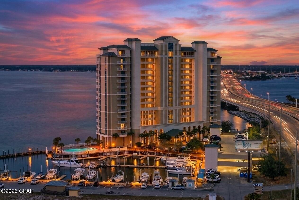 OPEN HOUSE SUN 9/6 1pm-3pm! Watch the sunrise and sunset from your private balcony! Marina Landing #601 is a beautiful 3 bedroom, 3 bathroom corner-unit condo featuring over 1,900 square feet of interior living space plus more than 600 square feet of wraparound balconies. This waterfront condo is located on the marina side directly overlooking St. Andrews Bay, with a marina next door offering boat slips available to lease. Lightly lived in as an occasional part-time retreat, the condo is in excellent condition and is move-in ready. It is being sold fully furnished with all furniture, appliances, décor, and home goods included -- just bring your clothes and enjoy waterfront living in Panama City Beach.
The bright BoHo Coastal interior features artisan and international décor, bright colors, and custom finishes throughout. The fully stocked chef's kitchen includes a dedicated coffee bar. Recent updates include a new water heater, washer, dryer, and refrigerator. This grandkid-friendly home is beach and paddleboard ready.
The huge wraparound balcony offers a bar, grill, and teak bar chairs with outstanding marina and bay views. Additional features include a large secure storage closet, prime parking space, private gym, owner private party area, and a private pier. The building has been newly painted with completed stucco restoration.
Marina Landing is a peaceful waterfront community with no vacation rentals allowed and a six-month minimum lease policy. This turnkey condo is ready for immediate enjoyment on St. Andrews Bay.
