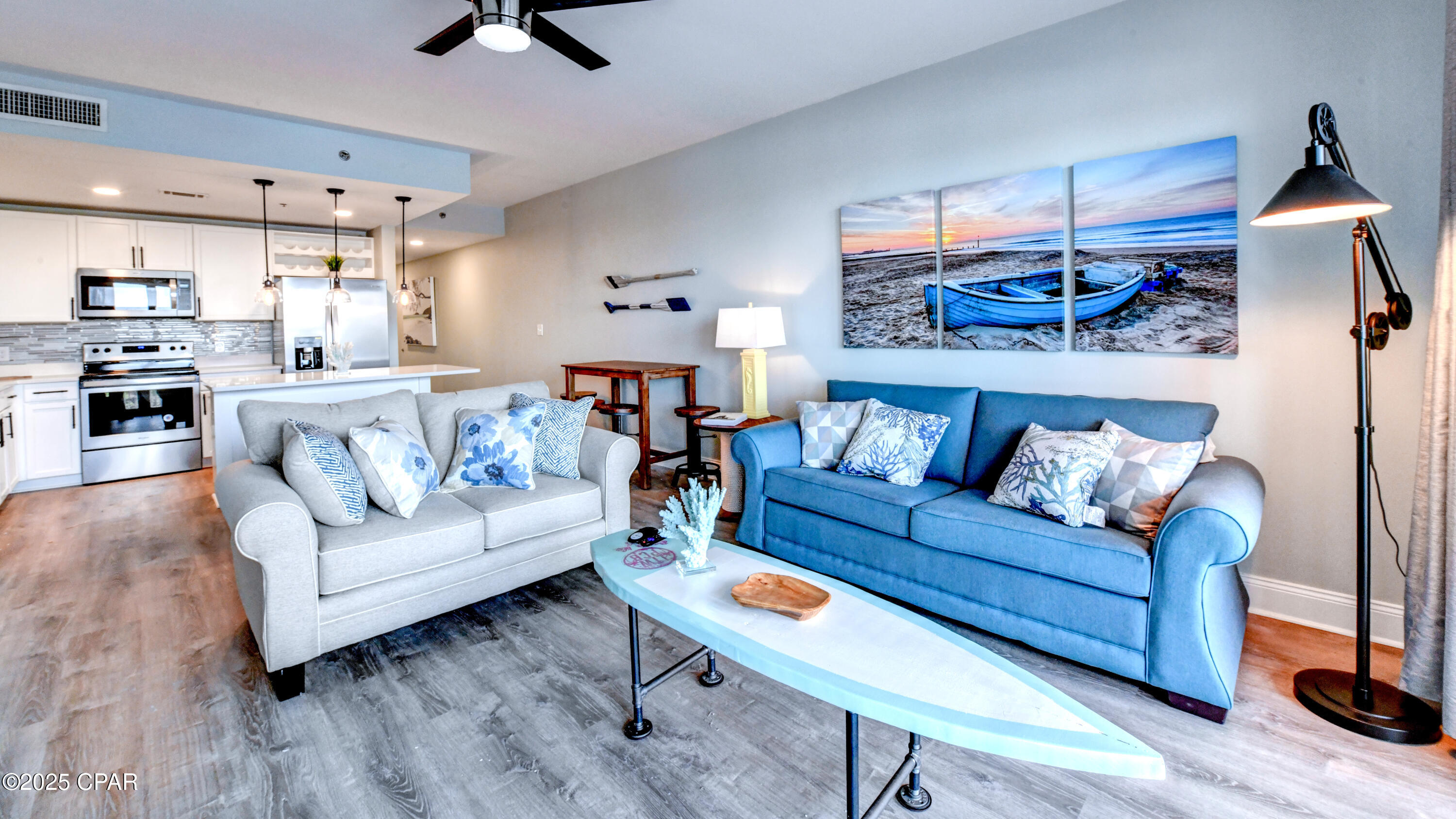 Experience coastal living at its finest in this beautifully updated 2-bedroom + bunk room, 2-bath condo at Laketown Wharf Resort. This turn-key property is fully furnished and already performing as a strong rental, offering an exceptional opportunity for investors or those seeking a stylish second home with income potential. The décor blends calming tones of blue, white, and gray with subtle splashes of color, creating a bright, inviting atmosphere from the moment you walk in.

The open living area is filled with natural light and flows seamlessly onto a spacious balcony overlooking the serene lake and resort surroundings. The primary suite also offers balcony access along with a generously sized ensuite featuring dual vanities, a soaking tub, and a separate walk-in shower. The guest bedroom and bunk room share a second full bath with a tub/shower combo, allowing the condo to sleep six comfortably and accommodate up to eight guests.

The kitchen is both functional and stylish, showcasing white cabinetry, a sleek gray tile backsplash, granite countertops, stainless steel appliances, LED lighting, and a breakfast bar ideal for casual dining or entertaining. Additional updates include new luxury vinyl plank flooring throughout and upgraded appliances, ensuring a clean, modern feel throughout the space.

Laketown Wharf delivers an impressive resort experience with multiple pools, a lakefront boardwalk, a Gulf-view fitness center, onsite dining, nightly fountain and light shows, and direct beach access just across the street. Its prime location places you steps from restaurants, shopping, and the iconic sugar-white sands of Panama City Beach. HOA dues include water, sewer, cable, WiFi, and access to all resort amenities (electric billed separately).

Offering strong rental history, stylish updates, and a turn-key setup, this condo is a standout opportunity in one of PCB's most popular vacation destinations. Ready for immediate enjoyment or continued rental success.