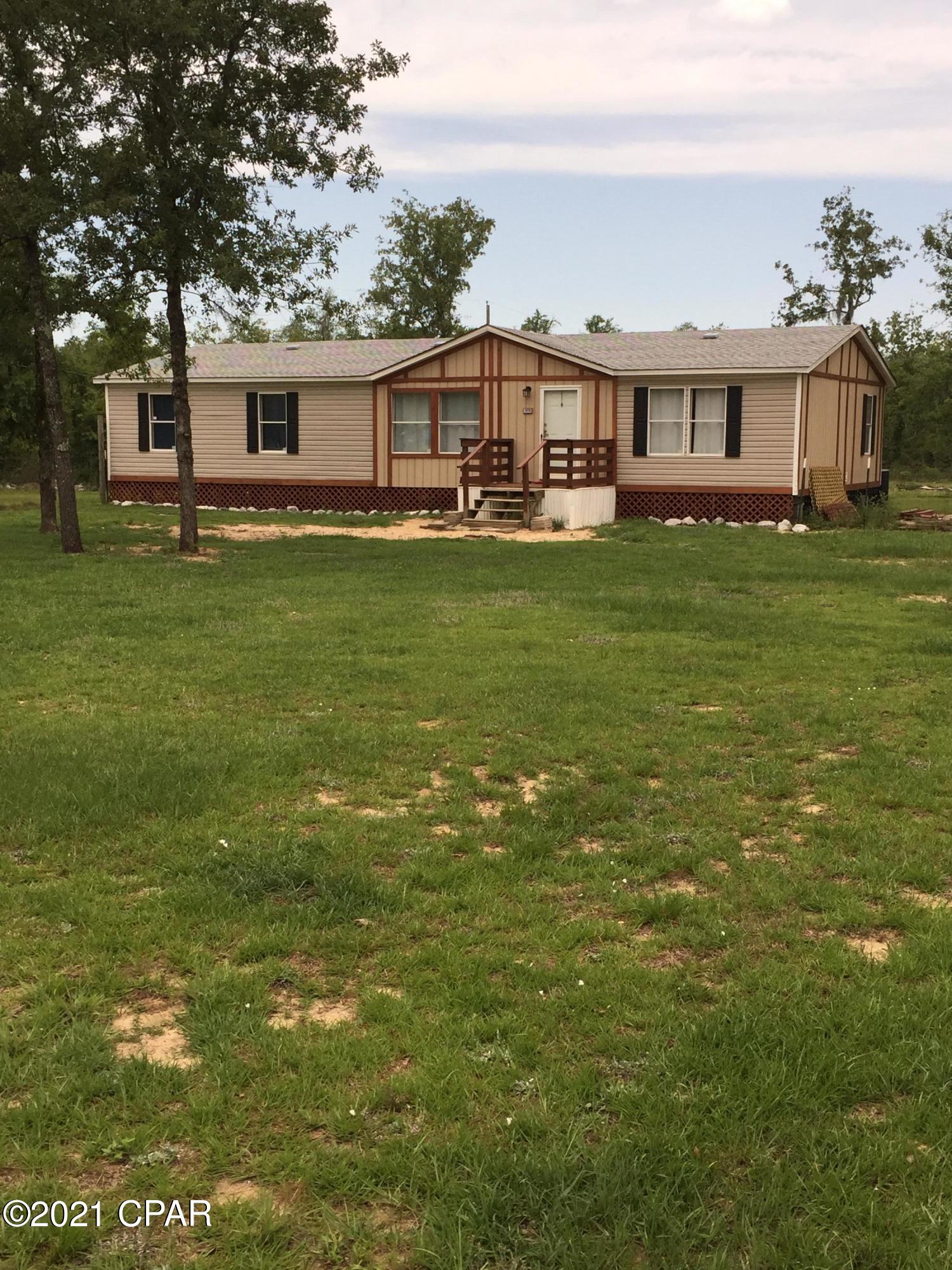 $115,000. 'CONTRACT PENDING'. Located in a country setting near Lake McKenzie, this home sits on 1.08-acre lot with fenced front yard and 2006 double-wide that was remodeled and updated within recent weeks.  The home has 1,456 sq. ft. of heated/cooled living space, with 3 BR's, 2 bathrooms, living room, den, dining area, kitchen with corner pantry, and laundry room.  Included are new ceiling fan/lights, new floors (some laminate plank, some ceramic tile, and some carpet), new paint throughout, and all appliances (Whirlpool washer, Maytag dryer, Whirlpool glasstop stove, refrigerator, dishwasher, microwave). Roof replaced after Hurricane Michael; new a/c condenser in 2019; new well tank and well pump. There are no outbuildings but the owner is leaving 210 bags of cement to be used for a future pole barn slab. Mall and shops in Panama City are about 35 miles away and Lake McKenzie public access is about 1.5 miles away. The electric power/meter box outside is new. The Seller also left some seasoned wood for burning in the stone fire pit out back. The porches are stained and sealed with Thompson Weather Stain and Seal. Buyer is to pay title insurance and all loan-related costs, as well as any amount above $125 for the title company's closing fee. Act quickly so this bargain doesn't get away from you!  $115,000.