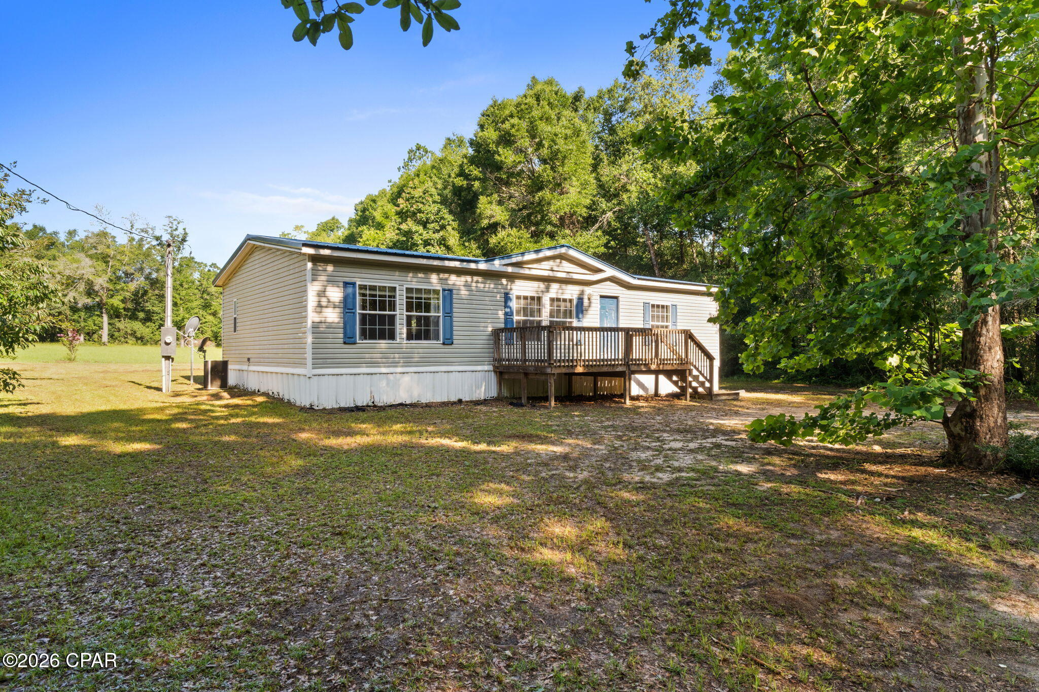 Charming 3/2 in a quiet and peaceful location. Just off Hwy 77 with great proximity to Panama City and Chipley. Move in ready. Spacious floorplan, beautiful flooring. Split bedroom layout giving privacy to the master which features a walk-in closet, double vanities, shower, and garden tub. Nice front deck and 2 workshops. City water. Priced to sell. USDA location for 100% financing.