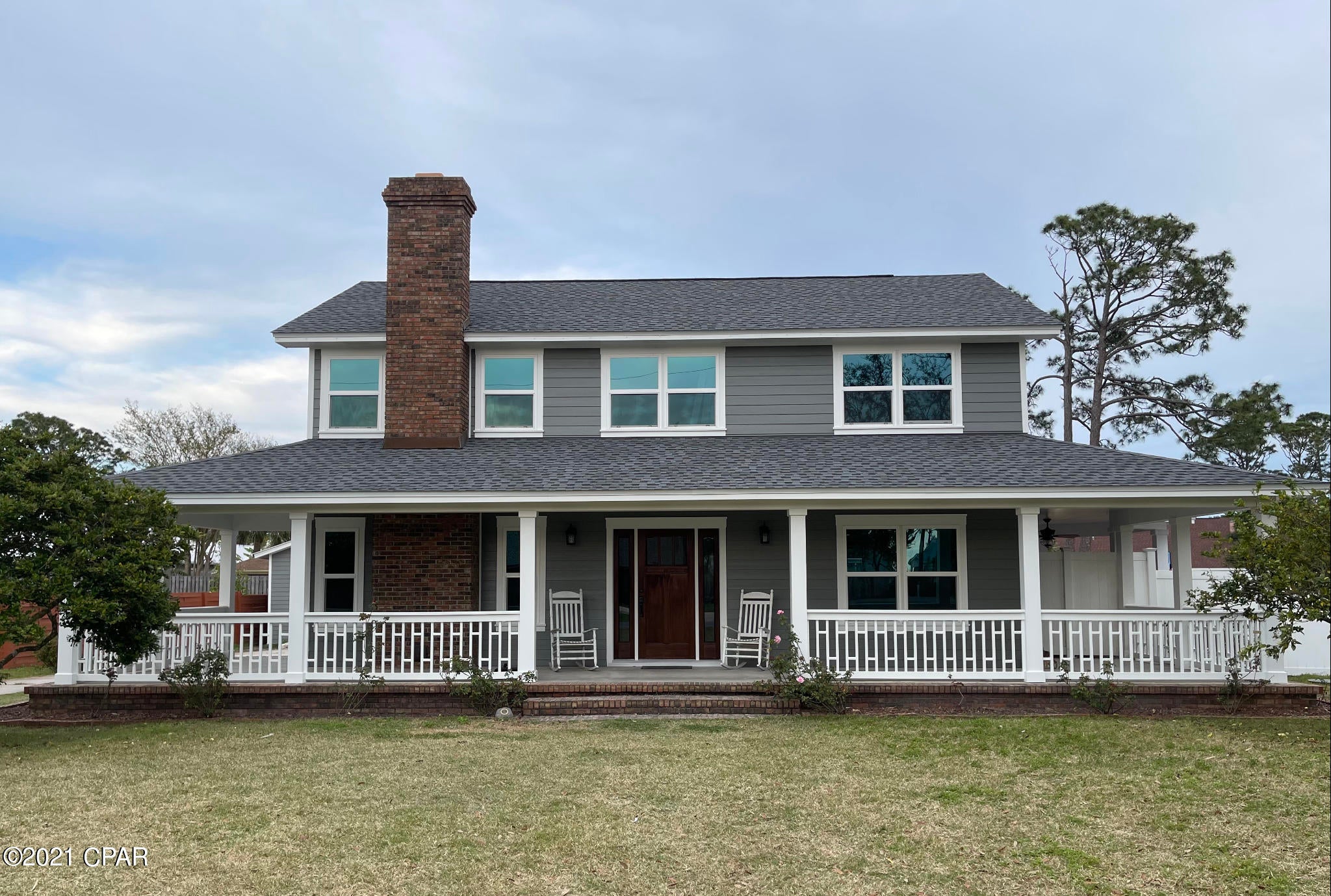 Beautiful home nestled in the highly sought-after North Lagoon area of Panama City Beach. This newly remodeled Coastal Craftsman home boasts a brand new seamless metal and GAF shingled roof, hardy board siding, high-impact resistant doors & windows, fresh paint and craftsman trim package throughout, a large open deck perfect for entertaining, detached workshop, 2 fireplaces. 4th BR would make a perfect home office. All appliances, washer, dryer,& 2 large flat screen tv's are included. New AC being installed 05/04. Did I mention fruit trees?! It is less than 5 minutes away from the sandy white beaches of the Gulf of Mexico, St Andrews State Park, award winning dining, shopping, & fun entertainment. No need to look further. Your s