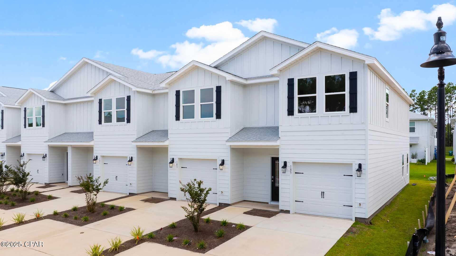 Welcome to 208 Ellery Lane at Bayside at Ward Creek in Panama City Beach Florida. This townhome is corner homesite and under construction. This townhome offers a welcoming space that has 3 bedrooms, 2.5 bathrooms, and a convenient single car garage. The bright entry leads to an open kitchen, living, and dining area that is designed for comfort and everyday living. The kitchen serves as the culinary center with a spacious center island, beautiful white cabinetry, granite countertops, and a premium stainless steel appliance package including a smooth top stove, microwave and dishwasher. Beautiful windows surround the living area allowing for natural light. 

The first floor is the heart of the home, while the privacy of the second level has all bedrooms, ensuring a quiet retreat. The main suite features a generous closet, an oversized shower, dual sink vanity, and a linen storage area in the private bath. Two additional bedrooms share a hall bath with shower tub combo that create a comfortable space for family or guests.   

 The interior features include EVP flooring throughout the main level and second level bathrooms and plush carpet on the stairs, upstairs hallway and bedrooms, Smart Home Technology Package comes standard, featuring a Qolsys IQ touch panel for thermostat and lighting control, ensuring security and convenience. Exterior features of Bayside at Ward Creek townhomes are equally impressive, with Hardie® siding and thoughtful lighting at the garage, front entry, and back patio. A landscaped front entry adds curb appeal and welcomes you to your very own slice of Florida paradise awaits. the back patio looks over the tree line with no neighbors behind you creating a great space to sit and enjoy nature. The community includes a pool, and playground just minutes away from the beautiful beaches, shopping and all the Panama City beach has to offer.  Call today for a tour of this floor plan.