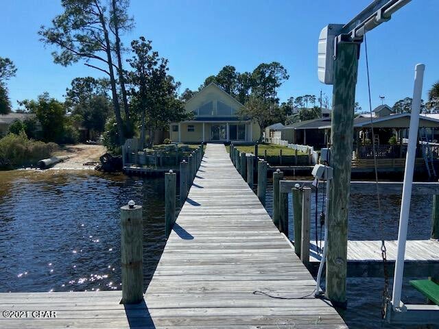 Beautiful location on the Deepest and Widest part of Grand Lagoon.  Home has Travertine Flooring throughout.  Spacious rooms, Cathedral ceilings,  Large spiral Staircase.   A large Loft overlooking the peaceful waters of Grand Lagoon.  NEW METAL  Roof  is being installed.  

Sea Wall /retaining Wall and Dock with Boat Lift recently redone.   Sea Wall has a ''Life-Time'' guarantee .    Just a short boat ride to the open waters of the Gulf of Mexico,  and a few blocks from the   beautiful white sandy beach.   



Home  is being priced and sold ''as is'' 

Measurements approximate.