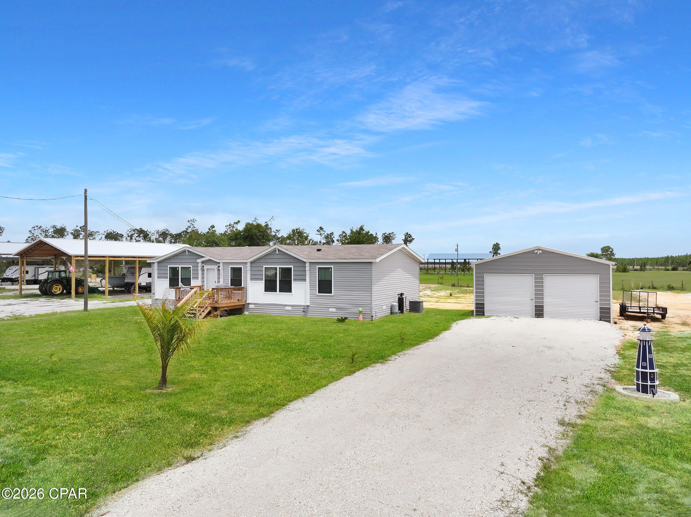 Have you been searching for the perfect coastal landing spot with enough room for all your gear? This is it. Located just 12 miles from the beautiful white sands of Saint Joe Beach and Mexico Beach, this high-and-dry property sits safely in an X Flood Zone on a generous half-acre lot. A beautifully designed 2025 manufactured home boasting 1,568 sq. ft. of immaculate living space. With a bright 3-bedroom, 2-bathroom split floor plan, a modern kitchen featuring stainless appliances and stone tops, and plenty of natural light, it's completely move-in ready. Bring the boat, the toys, and the tools! The brand-new, detached 50x24 metal building  is a rare find this close to the coast. Whether you need a mechanics workshop, a secure place to store your vehicles, or a massive hobby space, this heavy-duty garage has you covered. Skip the high insurance costs of the flood zones and the cramped quarters of the beach subdivisions. Enjoy space, freedom, and newer construction just minutes from the Gulf!