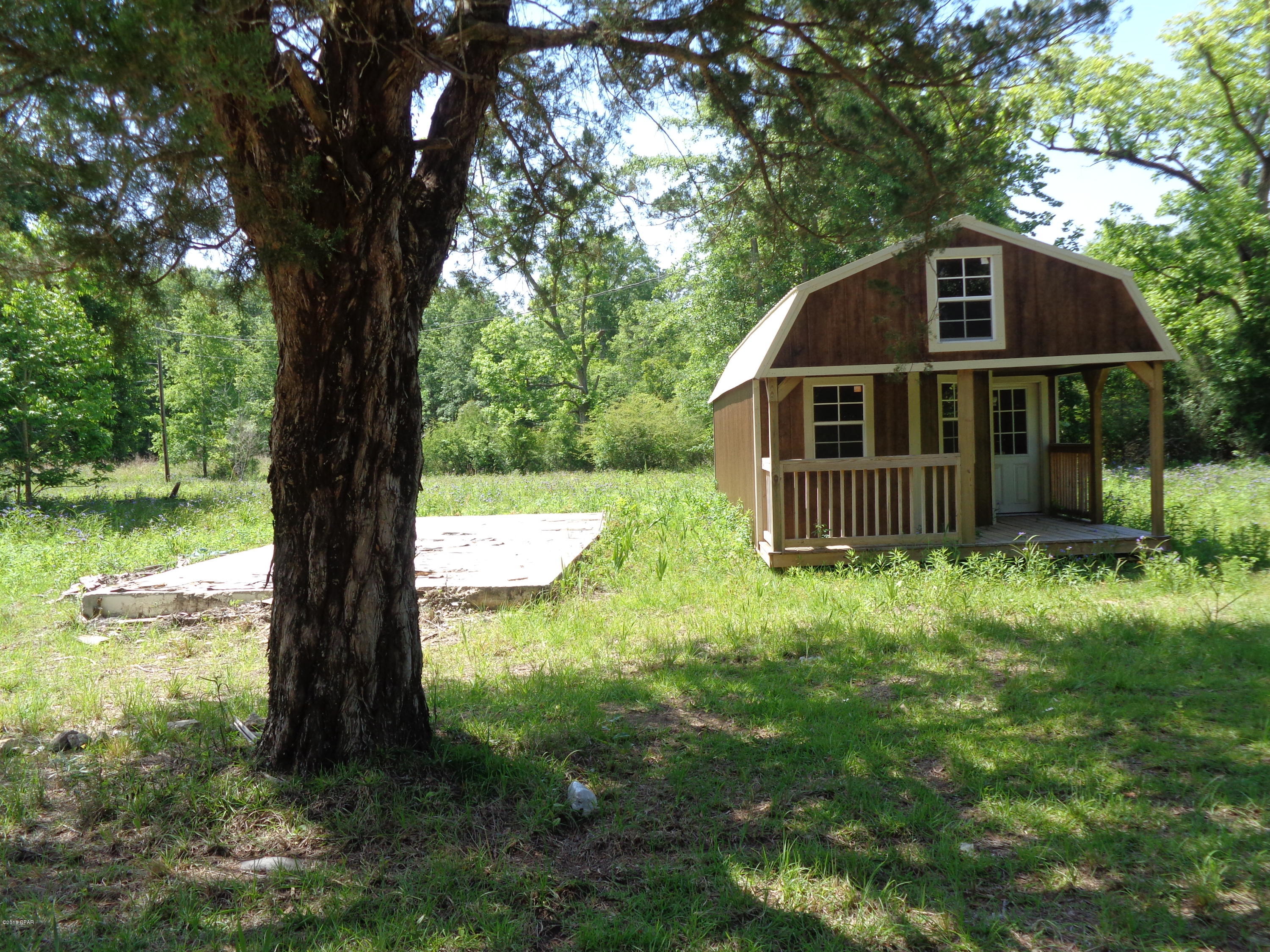 Nice lot located in Grand Ridge. There was a home on the property at one time. Rural setting with trees there is at this time a nice cabin type building. Looking for a place to build or mobile homes o.k