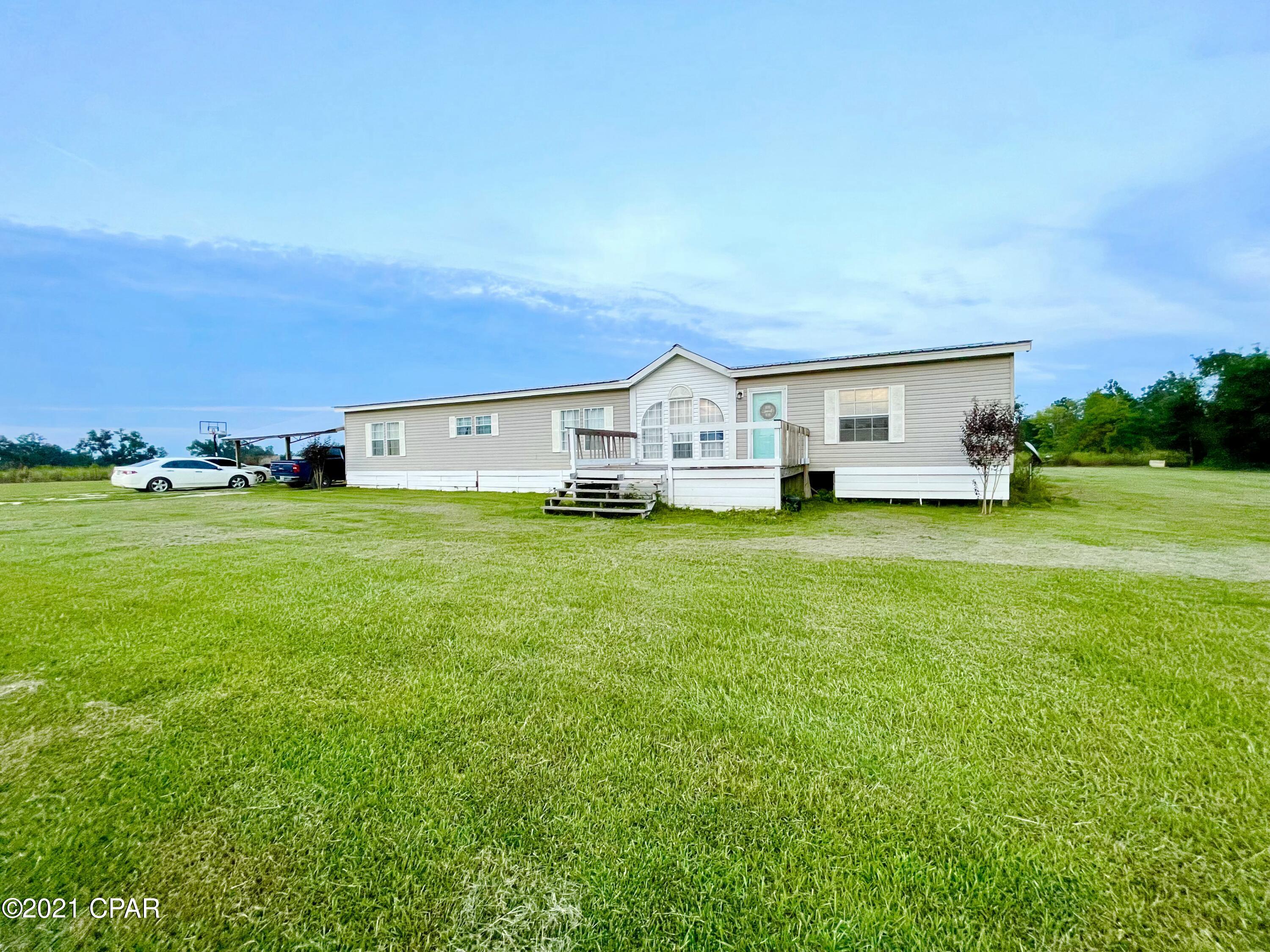 **CURRENTLY UNDER CONTRACT, SELLER ACCEPTING BACKUP OFFERS**

4/2 on 3.32 acres located just North of Grand Ridge off of Hwy 69 has been mostly remodeled and fenced for grazing. This home features an open living area floor plan and includes an office in addition to the four bed rooms. New flooring has been installed throughout and the kitchen has cabinet and counter space for days!!! Roof and HVAC are both less than three years old. Master bath has ample closet space, double vanities, and a custom built tile shower. The seller has done a lot of revamping to this manufactured house to make it feel like home including custom wood/tile work and textured walls. Make an appointment to take a look!!!