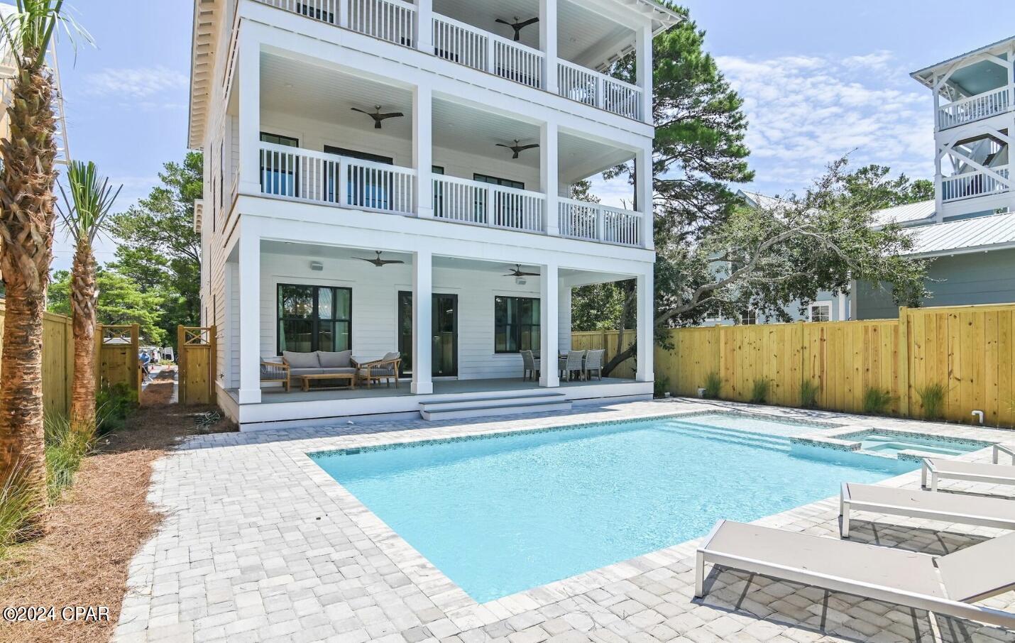 Immerse yourself in a symphony of sound, as the indoor living area and the outdoor heated pool/spa are equipped with Sonos surround sound.

Just steps away from the sprawling Eastern beach access, the allure of the ocean beckons. The front yard, embraced by a wooded landscape, grants both privacy and a touch of nature's tranquility.

This haven is turn-key and professionally decorated, making it rental ready and an ideal investment opportunity. Stay connected with the commercial-grade Wi-Fi system, and enjoy modern entertainment with included TVs.

In summary, this exceptional beach house encapsulates the essence of coastal opulence. Whether as a personal retreat or an income-generating asset, this is an invitation to experience luxury living in a class of its own. Seize this opportunity to own a slice of Florida
