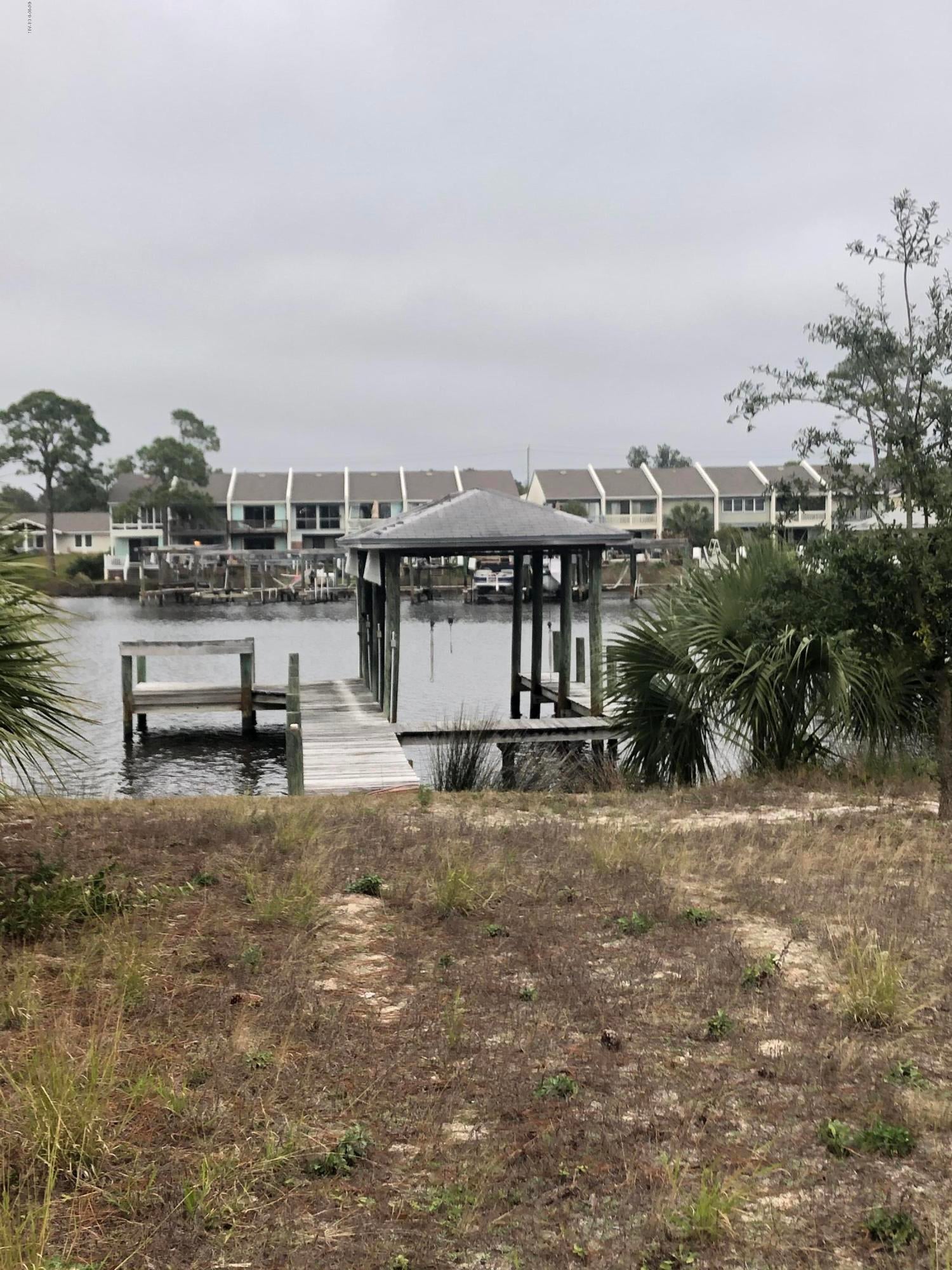 WATERFRONT S. Lagoon property featuring a covered boathouse slip and seawall. Perfect waterfront lot to build your dream home. Added bonus for this lot, it is in the middle of a no wake zone.