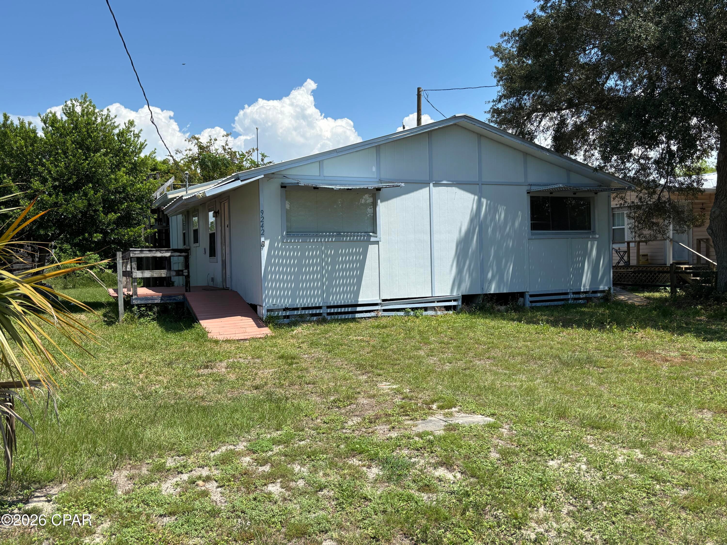 Coastal cottage in Beacon Hill located only 750' from a dedicated county beach access to the Gulf of Mexico! This home was formally set up as a duplex years ago and has many living options for those looking at the entry level of beach living along Florida's Forgotten Coast. Spacious kitchen/ dining area leads to a bedroom and full bath which flows to a back porch with two decks. The other side is suitable for other options such as a mother-in-law suite or bedroom with bath and is complete with a kitchen. Large workshop with plenty of storage for beach toys or hobbies. What's more, this unique property is also located in the coveted X FLOOD ZONE for better flood insurance rates. Don't miss out on this great opportunity to enjoy the sugar sand beaches of Beacon Hill and Gulf County, FL.