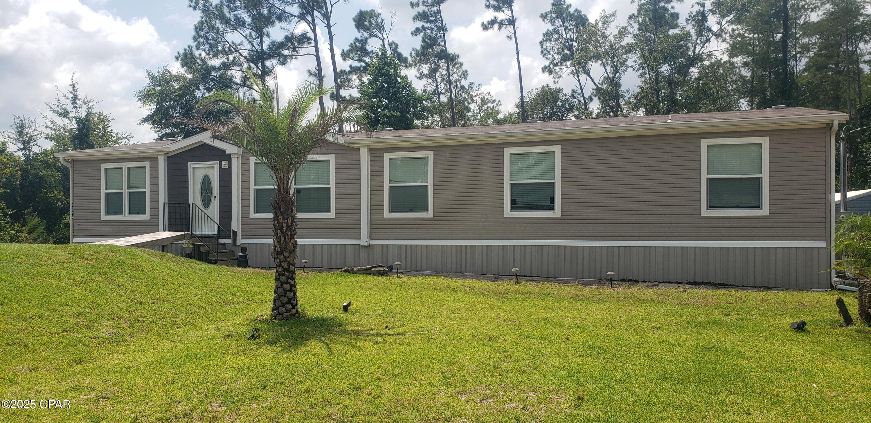 Spacious 4 Bedroom - 2 Bath double wide mobile home situated on 1.032 acres. This mobile home features an open floor plan with a great room and a den.  This allows plenty of room for the family to spread out. The fenced back yard is a great area for the children and pets to run and play. Do note that only a small portion of the 1 acre lot is fenced. The lot dimensions are given above: 162.28x242.53x186.27x277.90. The fence is 75 ft wide and 50 ft long. The Boat ramp is only 2.5 miles away. This is a nice  quiet area with large acre lots giving you privacy.  Make an appointment to see this property today.