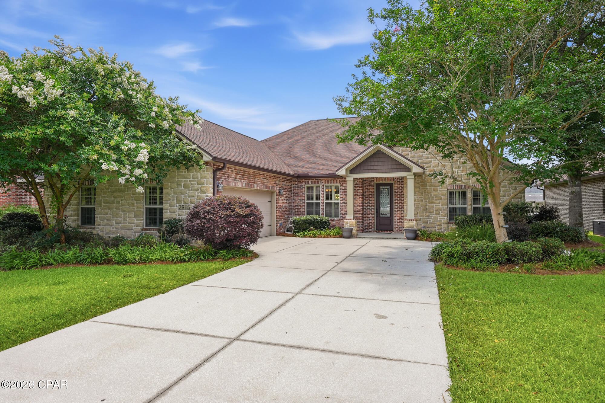 *CURRENTLY UNDER CONTRACT, SELLER WILL CONSIDER BACKUP OFFERS* Offering 2,938 square feet of well-appointed living space and soaring ceilings, this thoughtfully designed 4-bedroom, 3.5-bath custom Hawks Landing home showcases enduring style, generous proportions, and a highly functional open-concept floor plan. With all four bedrooms conveniently located on the main level and a versatile upper-level flex space above the garage, the home delivers both everyday comfort and remarkable adaptability to complement modern lifestyle needs.

The impressive main living area is anchored by an elegant tray ceiling, custom built-ins, wood floors, and a gas fireplace, creating an inviting atmosphere that feels elevated, polished, and effortlessly livable. Designed for everyday living and entertaining, the spacious Chef's kitchen serves as the heart of the home--featuring granite countertops, rich wood cabinetry, stainless appliances, double ovens, a large center island with breakfast bar, and a sunny breakfast nook overlooking the backyard. The adjoining oversized screened porch creates a seamless indoor-outdoor living experience, perfect for morning coffee, cheering on your favorite teams, enjoying movie nights, taking in stunning sunsets, or unwinding with an evening drink.

Privately situated within the split-bedroom floor plan, the substantial primary suite offers a peaceful retreat with a beautiful tray ceiling and French doors providing direct access to the covered back porch. The roomy en-suite bath includes two walk-in closets, a double vanity, a jetted soaking tub, separate tiled shower, and private water closet.

The formal dining room, accented by an exquisite coffered ceiling and plantation shutters, provides versatility for special occasions, a home office, or an additional gathering area. All secondary bedrooms are generously sized with ample closet storage and ceiling fans.

Upstairs, the bonus room with a private half bath and separate thermostat provides a dedicated area for a media room, guest quarters, home gym, playroom, or fifth bedroom.

Outside, the expansive fenced backyard offers exceptional space for recreation, relaxation, and hosting guests. Complete with a convenient gas stub for an outdoor grill, the covered porch extends your living space and creates the perfect setting for outdoor dining and year-round gatherings.

Significant recent improvements include a new roof (2019), HVAC system (2021), carpet (2023), innovative ''on-demand tank'' water heater (2024), and stainless-steel kitchen appliances that are all less than three years old.

Additional features include an oversized two-car garage with additional hobby/workshop space, laundry room with utility sink and tailored storage cabinetry, irrigation system, seamless gutters, and enhanced exterior doors from the kitchen, primary suite, and third full bath to the covered and screened porches with integrated between-the-glass blinds, offering convenient privacy and custom light control.

Hawks Landing is a desirable planned community offering a welcoming neighborhood setting with custom-style homes, inviting sidewalks ideal for neighborhood strolls, and a central location with convenient access to Tyndall Air Force Base, NSA Panama City, hospitals, and other major employers, as well as top local schools. Residents also enjoy close access to recreation and everyday amenities, including the Lynn Haven Sports Complex, Deer Point Lake, nearby shopping and dining, multiple golf courses, and the sugar-sand beaches along the nearby Gulf Coast.

This move-in-ready and beautifully maintained home combines timeless design, modern enhancements, and adaptable living options suited for every stage of life. Whether you're entertaining, working from home, or simply enjoying everyday life, you'll appreciate its versatility today and for years to come. 

ASSUMABLE 3.625% VA Loan available for qualified VA-eligible buyers w/sufficient VA entitlement!