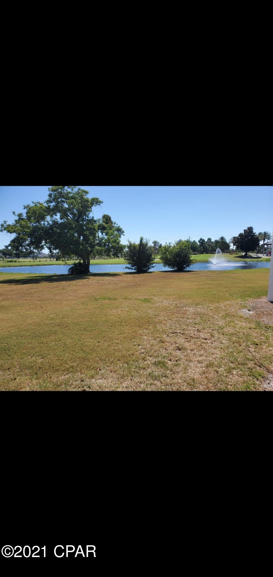 Park close to your GROUND FLOOR unit in one of the most sought after neighborhoods in Panama City Beach. No need to worry about climbing steps here. BAY POINT has security manned gates, a separate post office, a golf course, community events, and a new ''St. Joe'' marina in the works. This is a friendly and safe feeling golf cart community that should please even the hardest to please! You can watch the golfers outside your new sliding doors at the very first pin! You could even take the short walk across the street to see the future Marina and the gorgeous sunsets. People who live here love the fact they are close to most of the best restaurants & grocery stores in PCB. You should buy this for a permanent residence, a short OR long term rental or a beautiful home away from home!