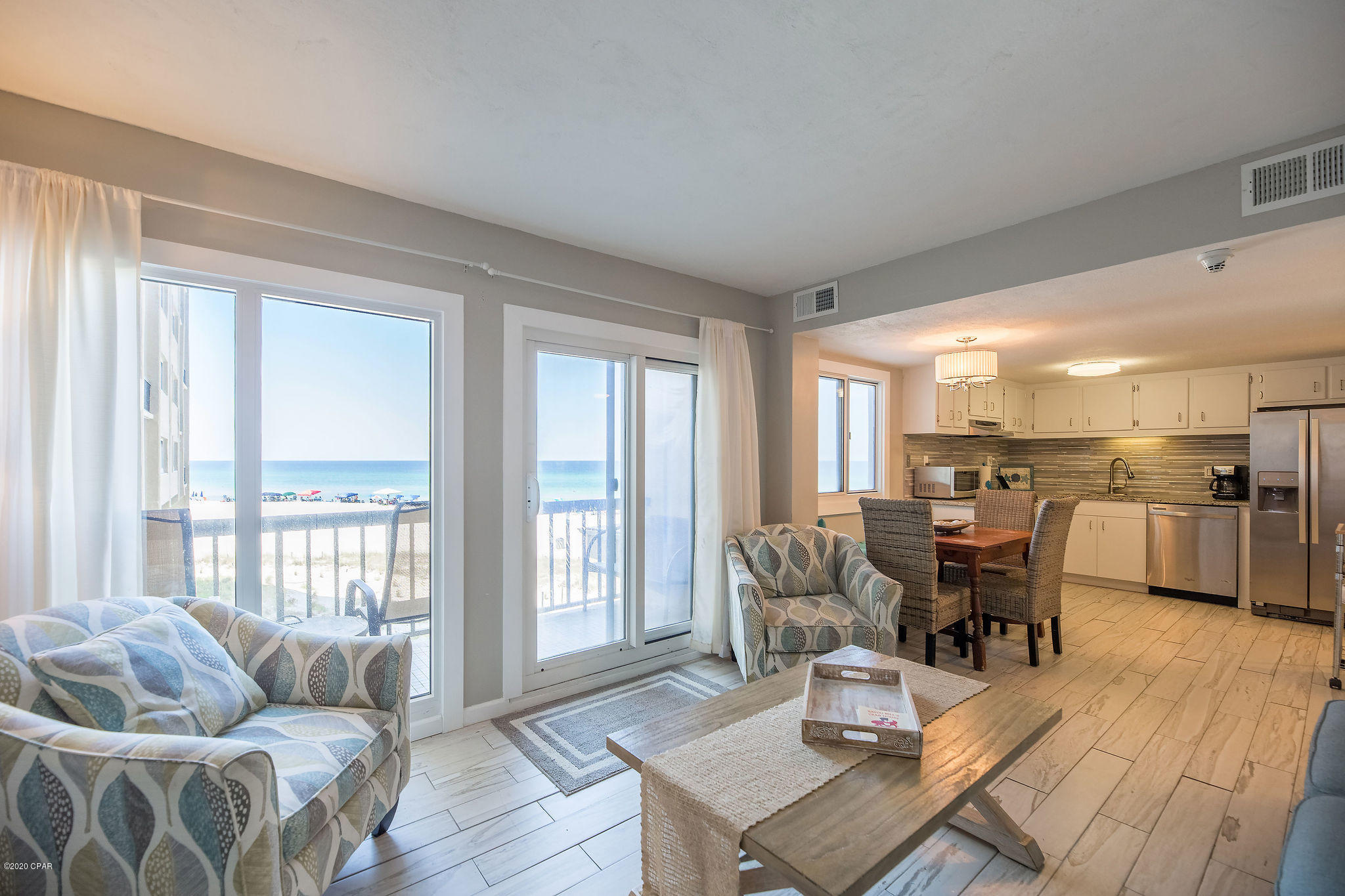This is a beautiful, upgraded, 2 bedroom/2.5 bath townhouse-style unit on the desirable first floor of Pinnacle Port's main building. The living room and its balcony have Gulf Views! The unit comes fully furnished and ready for vacation rental. Pinnacle Port is nestled within the gated community of Carillon Beach and is one of the quietest sections of the beach with uncrowded beaches for miles!! Amenities include two swimming pools, tennis courts sauna/steam room, fitness room, its own private freshwater dock with boat slips boat launch and wi-fi. HOA fees even include electricity for heating, cooling and hot water.