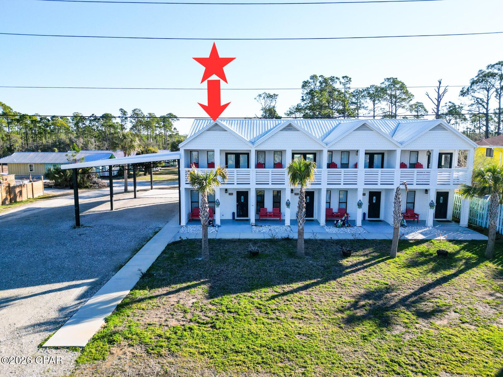 End unit with side carport and extra land that is part of a quadplex across the street from the Gulf of America. Unit is a 2 bedroom 1 full and 1/2 bath with an open floor plan and gulf views. These completely furnished units have a covered front porch, second story covered deck off of a top bedroom with Gulf of America views. Need to entertain or just want extra space? There is a spacious back patio that is partitioned for privacy, large back yard, and side covered parking gives the property many options for added features or expansion versus similar beach multi unit residences. There is a recorded beach access pedestrian easement for easy beach access right across the street. Conveniently located equidistant between Port St Joe and Mexico Beach for a variety entertainment options. The subdivision is decades old and has its own ingress and egress road with no thru traffic. NO HOA!! All units are in an X flood zone per the Gulf PA website, part of the added covered parking is in an AE zone. Verify if important. Some dimensions taken from the Gulf County Property Appraiser's website, please verify if important.