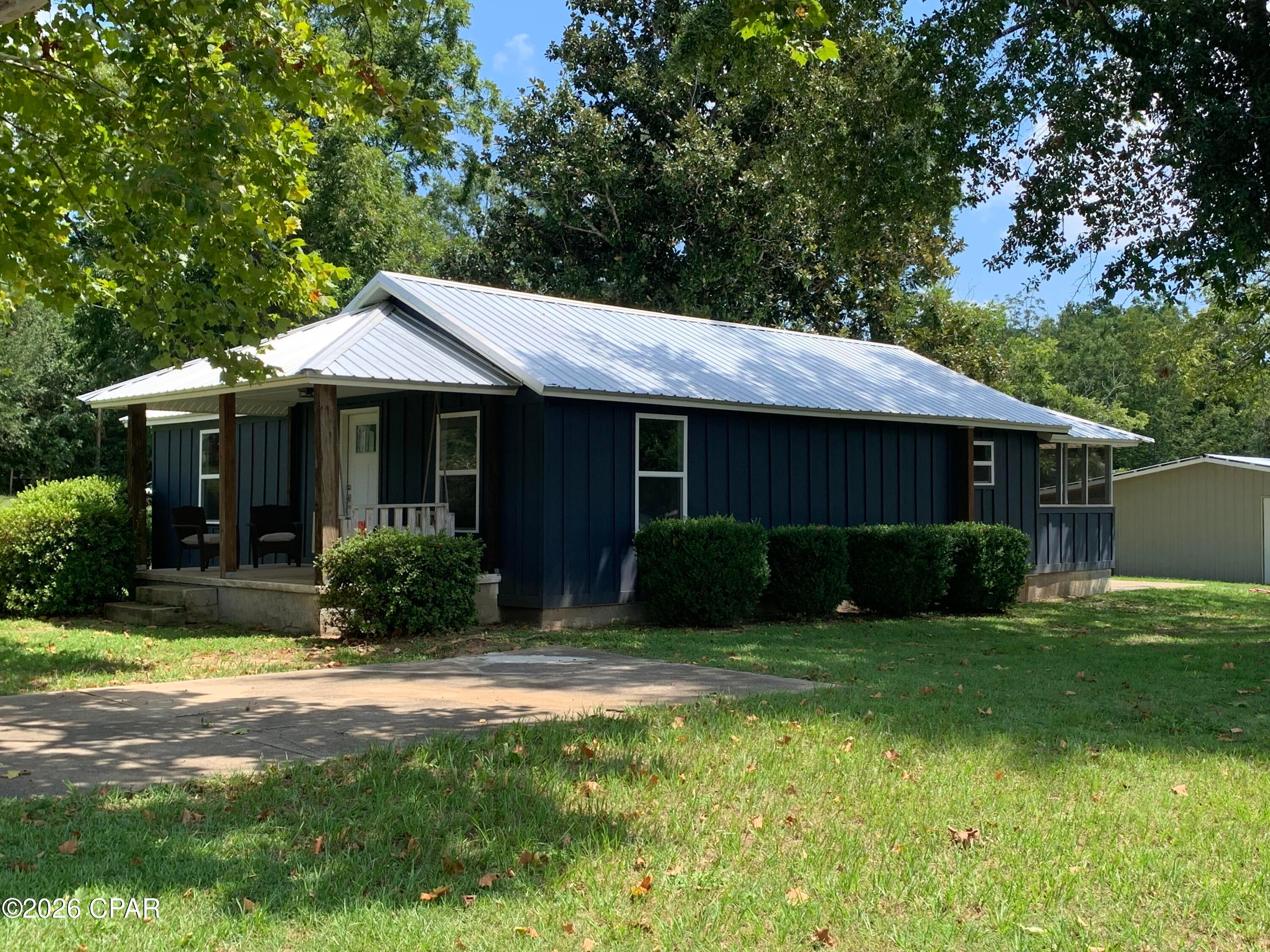 Pended, under contract, taking back-ups. Really Nice Turn-Key Home & Shop in a wonderful location! This 1726 square feet under-roof, 1400 square foot HVAC home has been fully renovated and updated! New outside central air conditioning unit! Newly painted throughout inside & out and lots of new upgrades!  It boasts new wood-laminate flooring and new kitchen cabinets! It is almost fully furnished! The really Nice Furniture in the pictures in this listing goes with the home (if the buyer wants it). Yes, you can move in immediately! Just move in and relax! It has it's on 4 inch-deep-well in an enclosed pump house and (also) has city water availability by turning on a valve. So that means you can water your lawn or garden at minimal expense and eliminate treated city water! The lawn is big and has beautiful shrubs and trees! It has 2 gorgeous sycamore trees and several oaks. And it has 4 nice producing pecan trees! There are no deed restrictions, so bring your boats and your RV! Plenty of room to park them! With that said: IT HAS A WONDERFUL FULLY ENCLOSED 30 ft x 38 ft SHOP!  YES, this separate building shop is 1,140 SQUARE FEET ENCLOSED! The shop has a garage door and another walk in door! It has 2 fluorescent lights and a number of electrical outlets and a nice big exhaust fan! YES, the shop has a concrete floor! Both the home and shop have metal roofs that are in excellent condition! NO LEAKS! Plus this home has TWO COVERED PORCHES!! Enjoy sitting on the swing (that comes with the home) on the large 16x9 FRONT PORCH! Or relaxing on the 
HUGE SCREENED 20x8 BACK PORCH! (Easily enclosed for another future bedroom). Sneads is a quiet safe community to reside in! It has a large Piggly Wiggly and a nice hardware store and other shops and service stations that are convenient. But the real thing that makes this a sportsman's dream is LAKE SEMINOLE! You will be less than a mile from this 38,000-acre lake where the Chattahoochee River meets the Flint River and forms the Apalachicola River! Lake Seminole is famous for its bass fishing and duck hunting! Nearby boat landings and parks! Three Rivers State Park is just down the road from this home! And then Apalachee Wildlife Management Area is right down the road on River Road! This home is in a wonderful neighborhood and the homes that are surrounding it are very nice and well kept! Some of the pictures in this listing will show some next door-across street neighboring homes. Simply put: A GREAT PLACE TO LIVE!