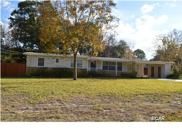 Location, Location, Location! Near 23rd St., Colleges, boat ramp, and a short drive to the beach. This updated home is surrounded by other nice homes on a quiet street. New interior & exterior paint, new flooring, lighting and blinds. Original Red Oak hardwood floors were refinished in 2012. The Master bath has been completely renovated. There is a formal dining room in addition to an eat-in kitchen. There is also a large ''den'' with a fireplace. This multi-functional room could be a 4th bedroom or office. The home sits on a large, almost 1/2 acre fenced lot and has a workshop/garage on the property as well as mature pecan and fruit trees. In addition to the workshop, there is a nice outside storage area off of the carport. A four zone whole yard sprinkler system utilizes well water.